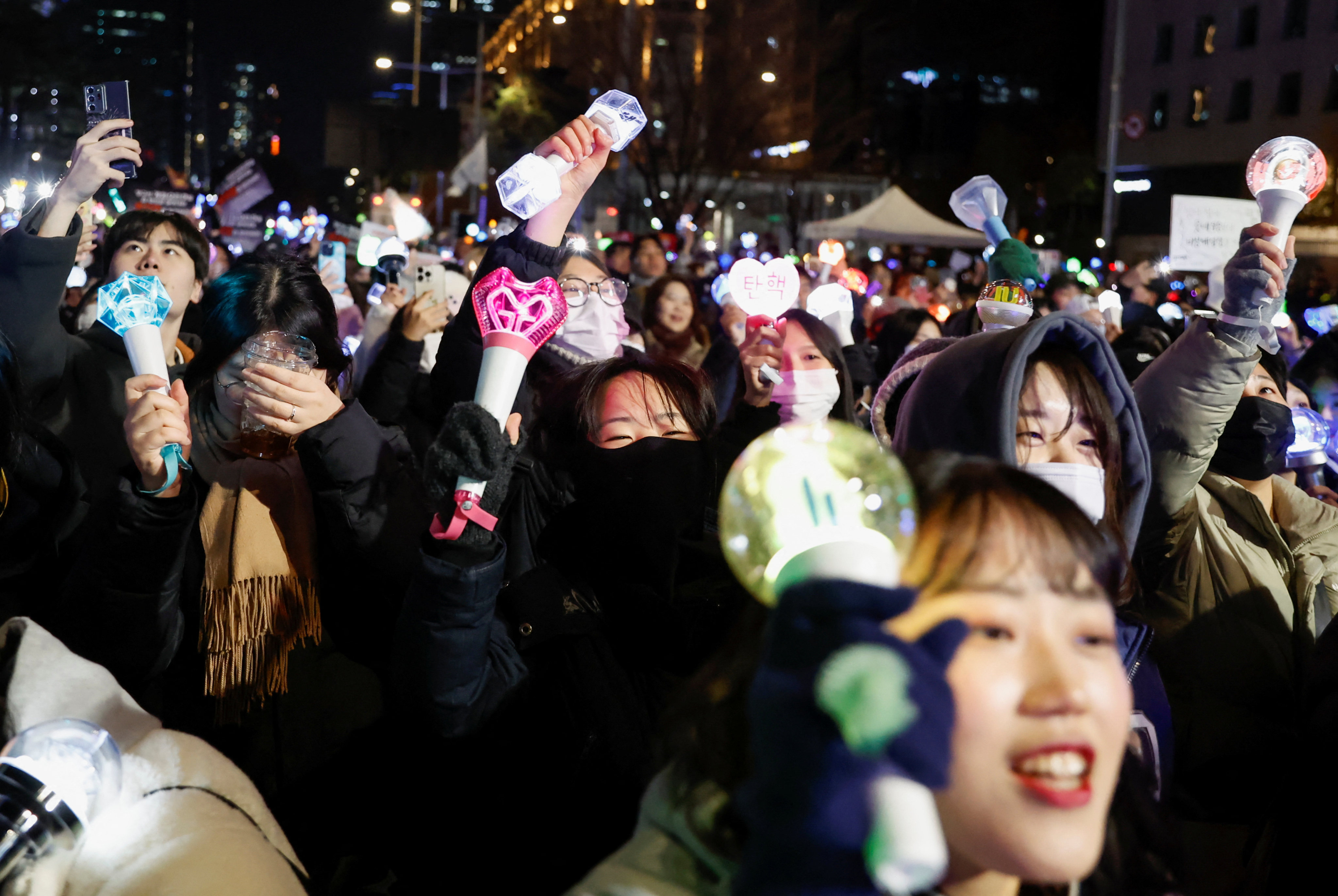 People carry K-pop idol sticks, as protesters take part in a rally on Sunday calling for the impeachment of South Korean President Yoon Suk-yeol. Photo: Reuters