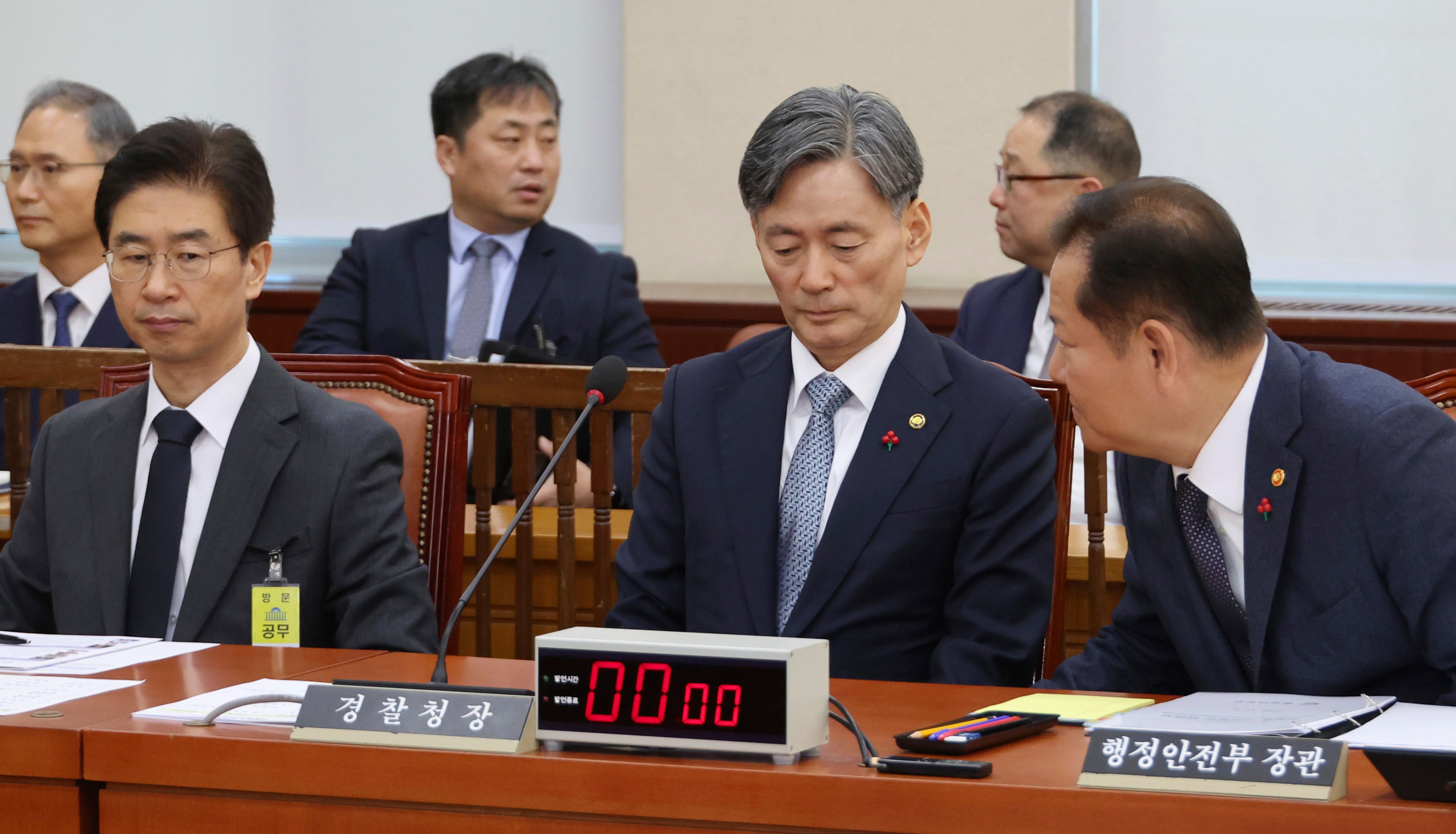 South Korean Interior and Safety Minister Lee Sang-min, (right) talks with National Police Agency Commissioner General Cho Ji-ho and Kim Bong-sik (left) head of the metropolitan police agency of Seoul, at the National Assembly in Seoul last week. Photo: Yonhap via AP