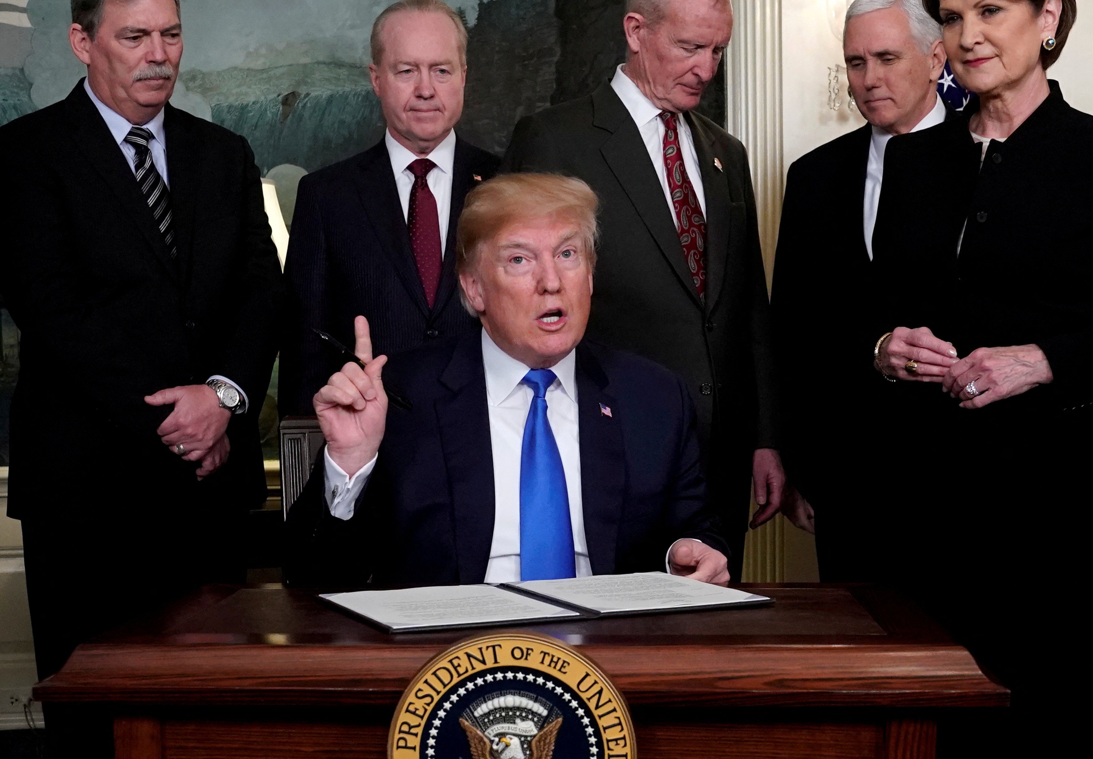 US President Donald Trump prepares to sign a memorandum on intellectual property tariffs on hi-tech goods from China at the White House in Washington on March 22, 2018. Photo: Reuters