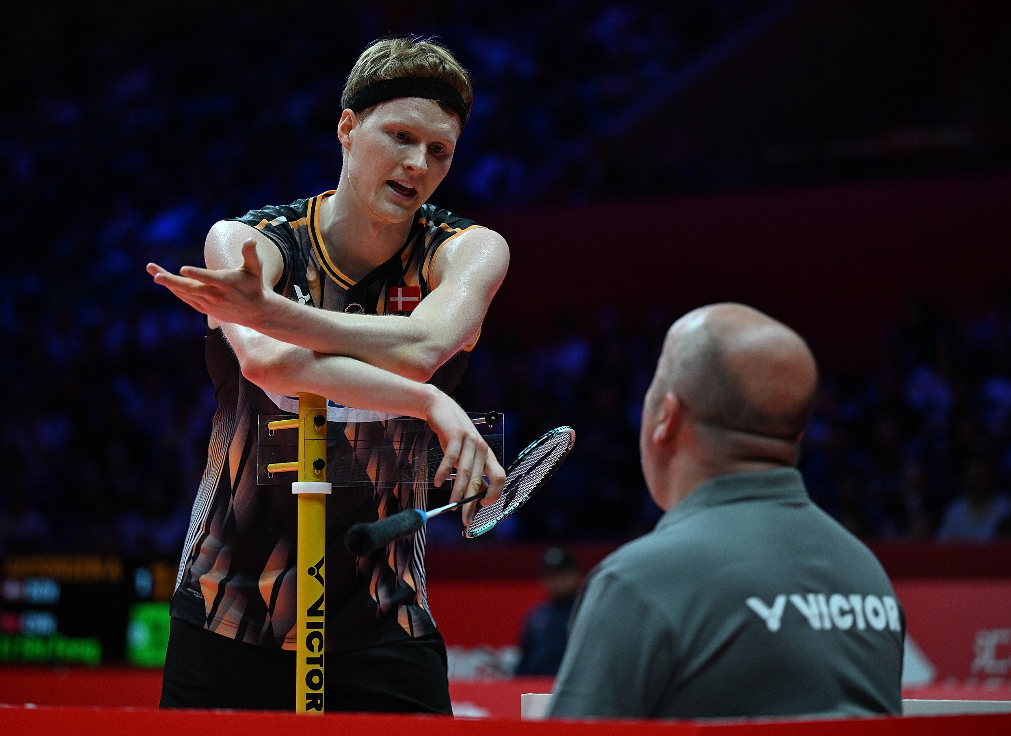 Anders Antonsen (left) talks to the referee during his men’s singles match against Li Shifeng. Photo: Xinhua
