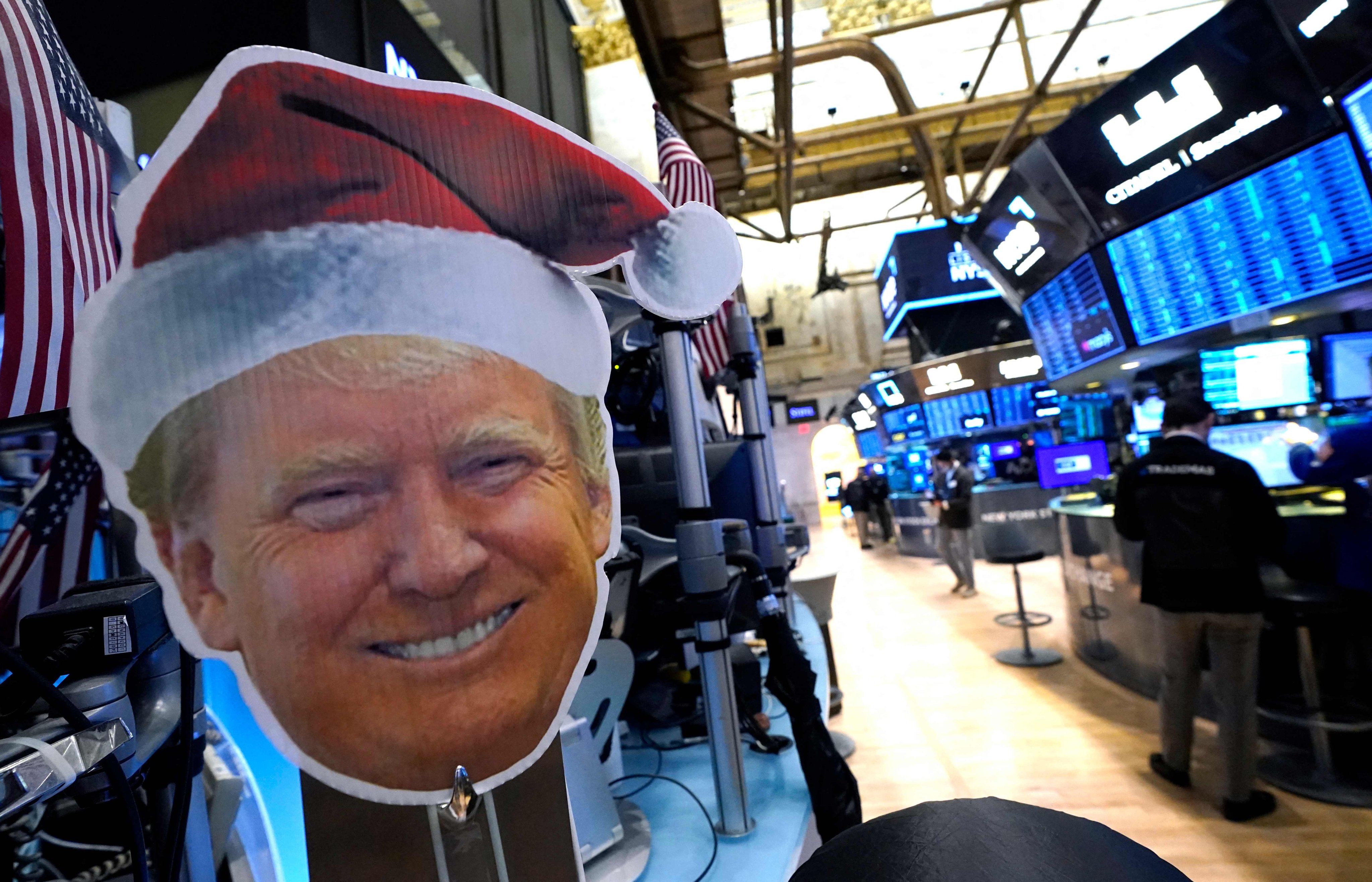 An image of US president-elect Donald Trump is displayed as traders work on the floor of the New York Stock Exchange on November 26. Photo: AFP
