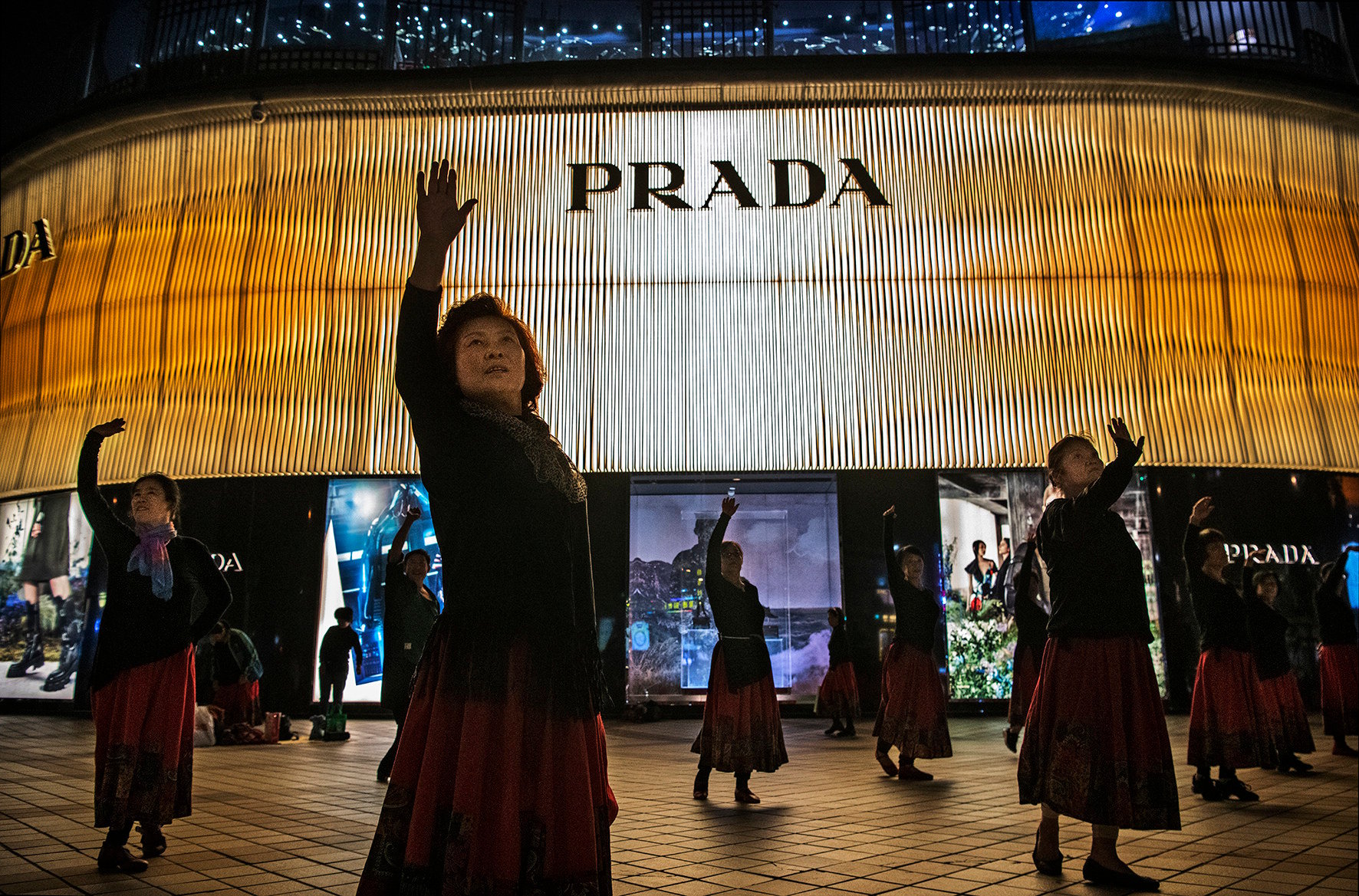 Women danced outside a Prada store in Beijing. Photo: Getty Images