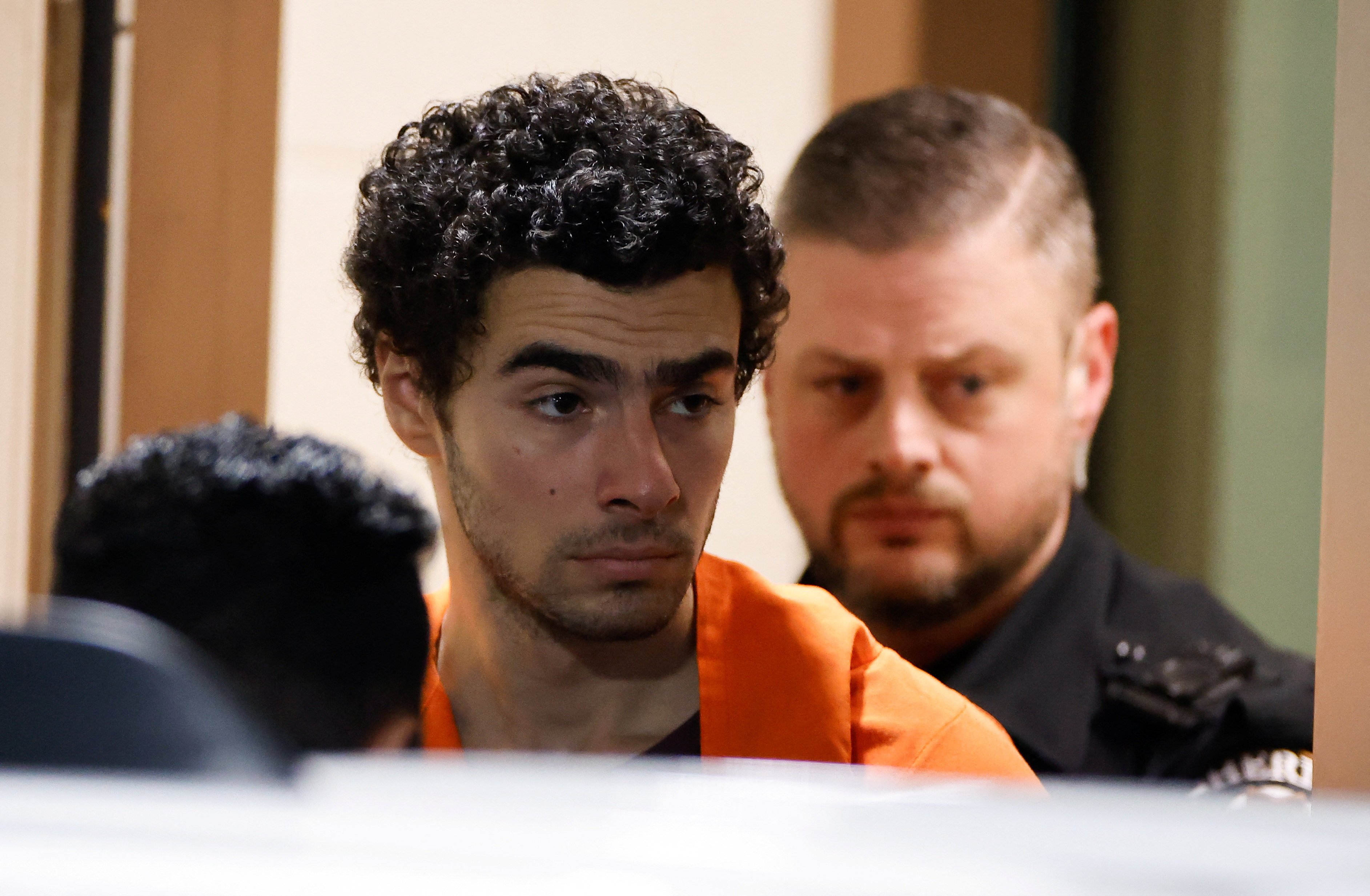 Luigi Mangione, a suspect in the New York killing of UnitedHealthcare CEO Brian Thompson, is escorted after an extradition hearing at Blair County Court House in Hollidaysburg, Pennsylvania, on Tuesday. Photo: Reuters