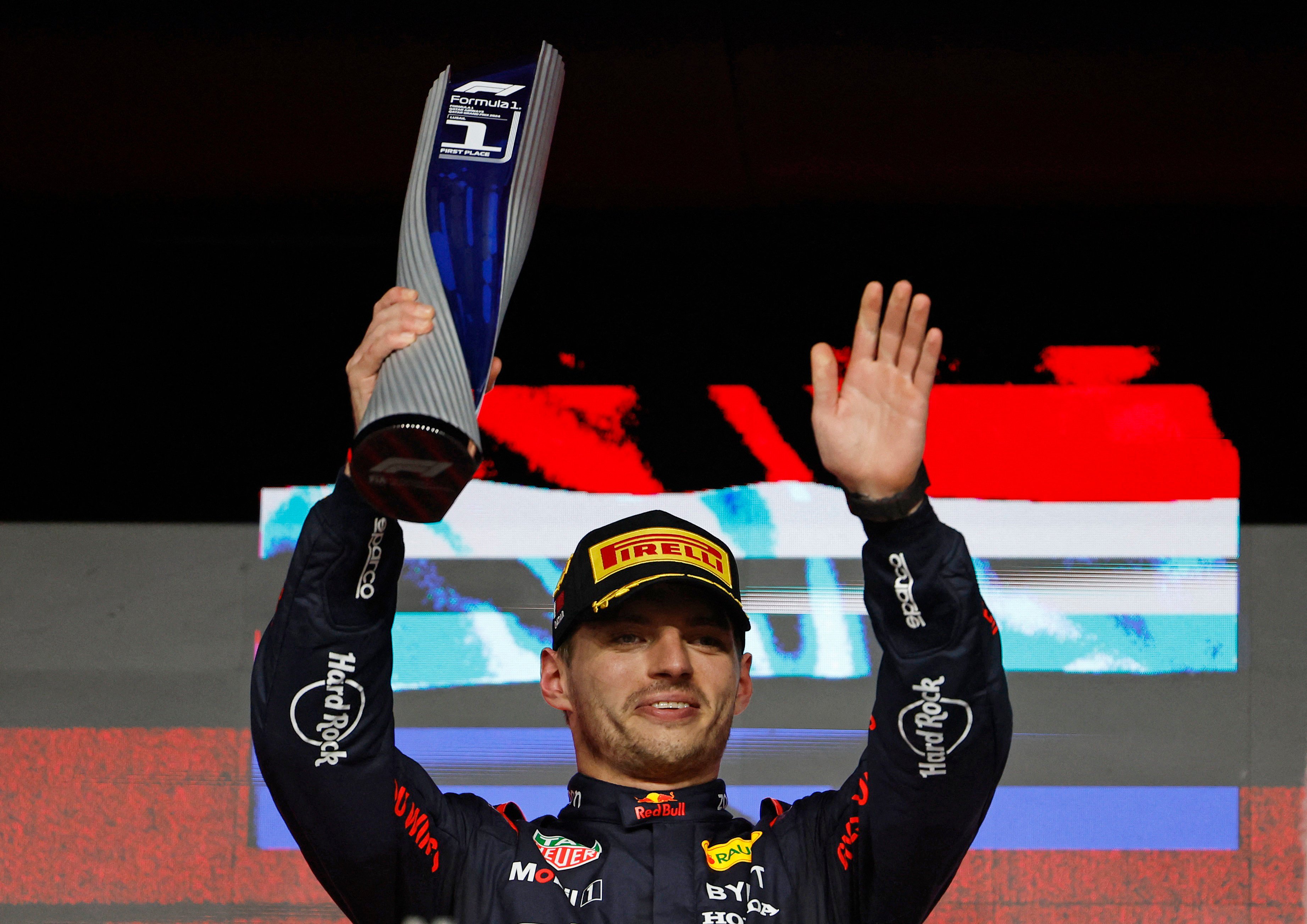 Red Bull’s Max Verstappen celebrates with a trophy on the podium after winning the Qatar Grand Prix in early December to clinch the title. Photo: Reuters
