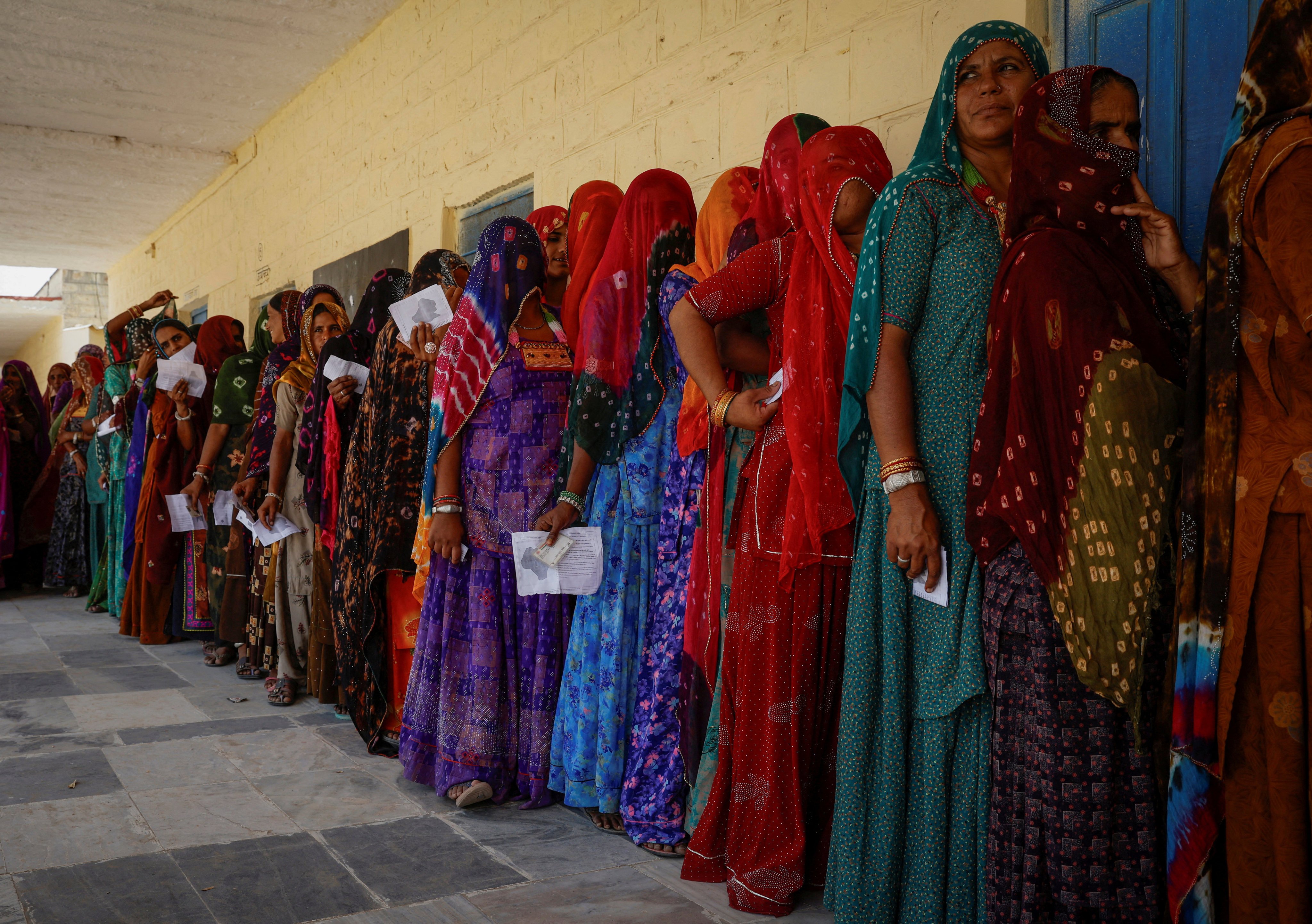 Women stand in a queue to cast their vote at a polling station during the second phase of the general elections, in Barmer, Rajasthan, India, on April 26. Photo: Reuters