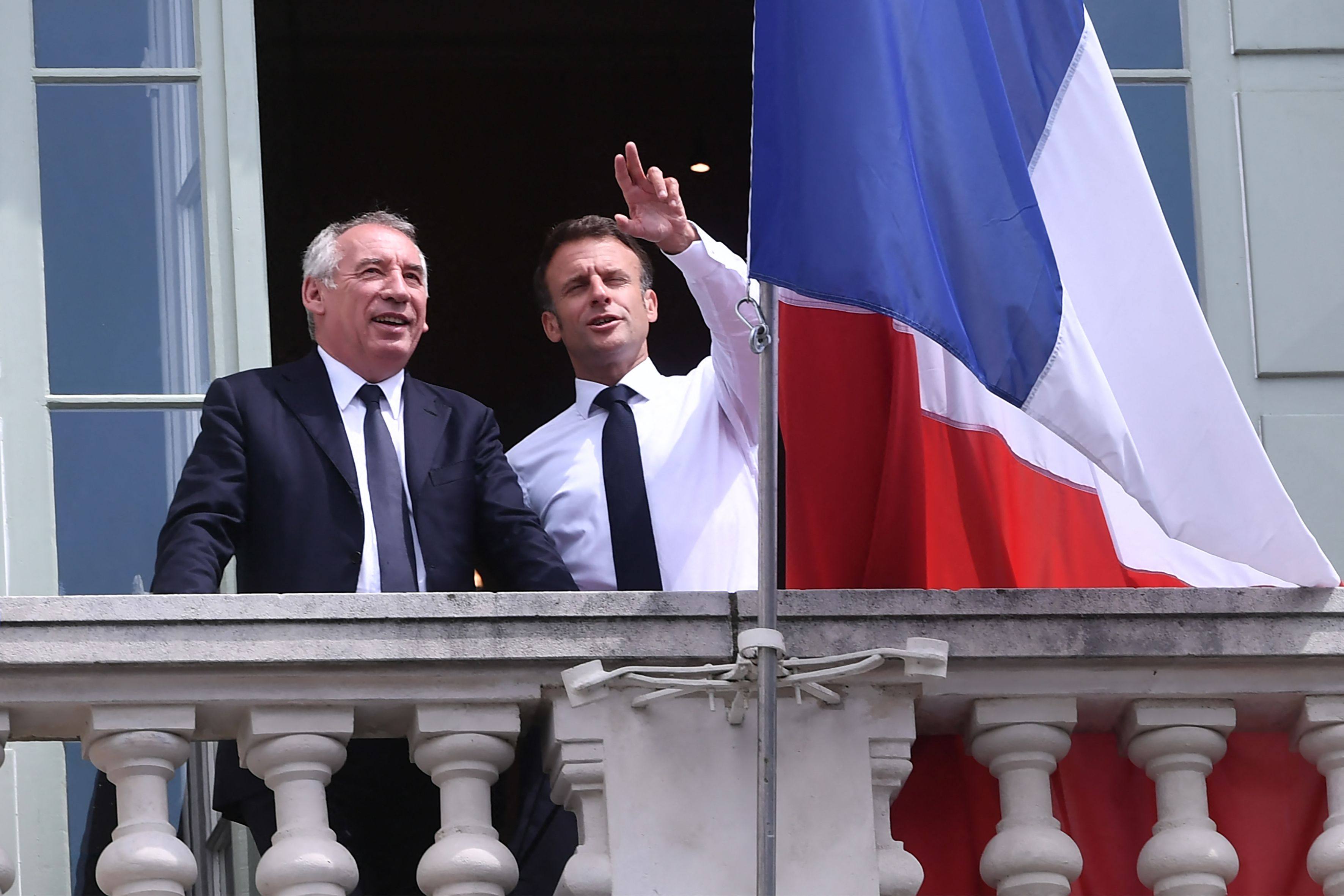 French President Emmanuel Macron (right) and president of the Modem party Francois Bayrou stand on the balcony of the city hall during a visit in Pau, southwestern France in 2023. Macron named Bayrou prime minister, the Elysee presidential palace announced. Photo: AFP