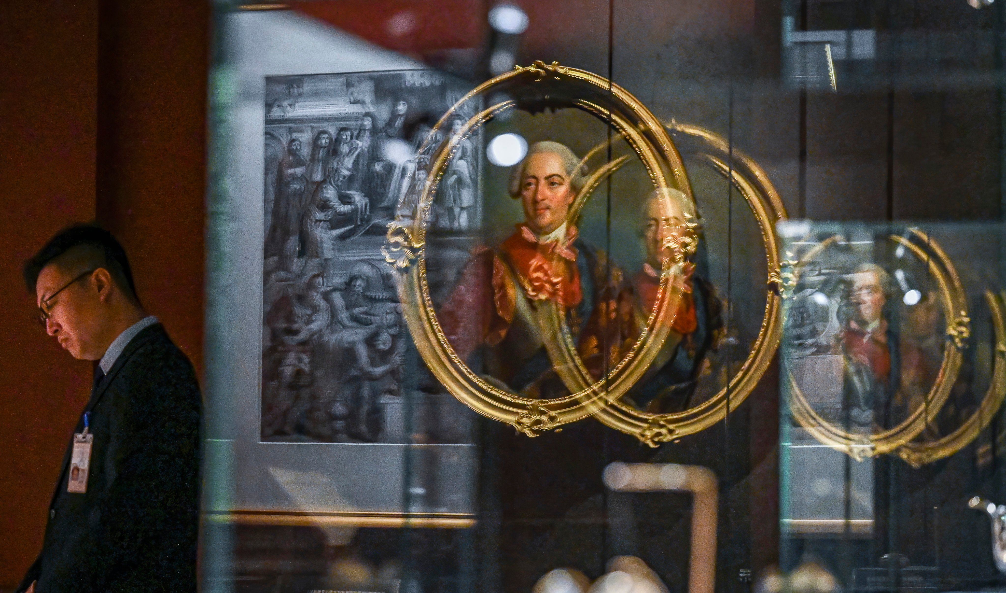 A staff member looks on during a media preview of “The Forbidden City and the Palace of Versailles” exhibition, which marks the long-standing relationship between China and France. Photo: AP