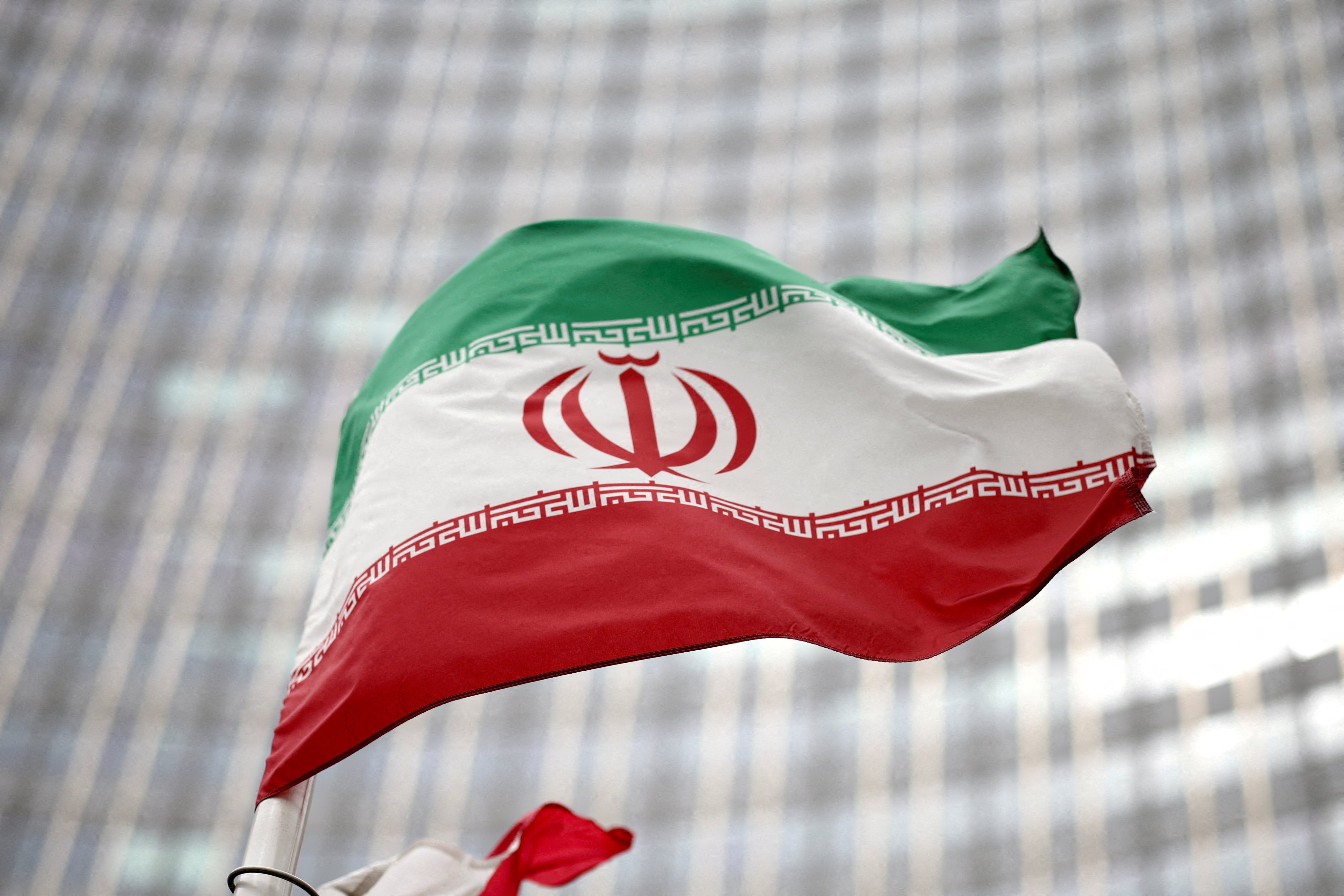 An Iranian flag flies in front of the UN office building. Photo: Reuters