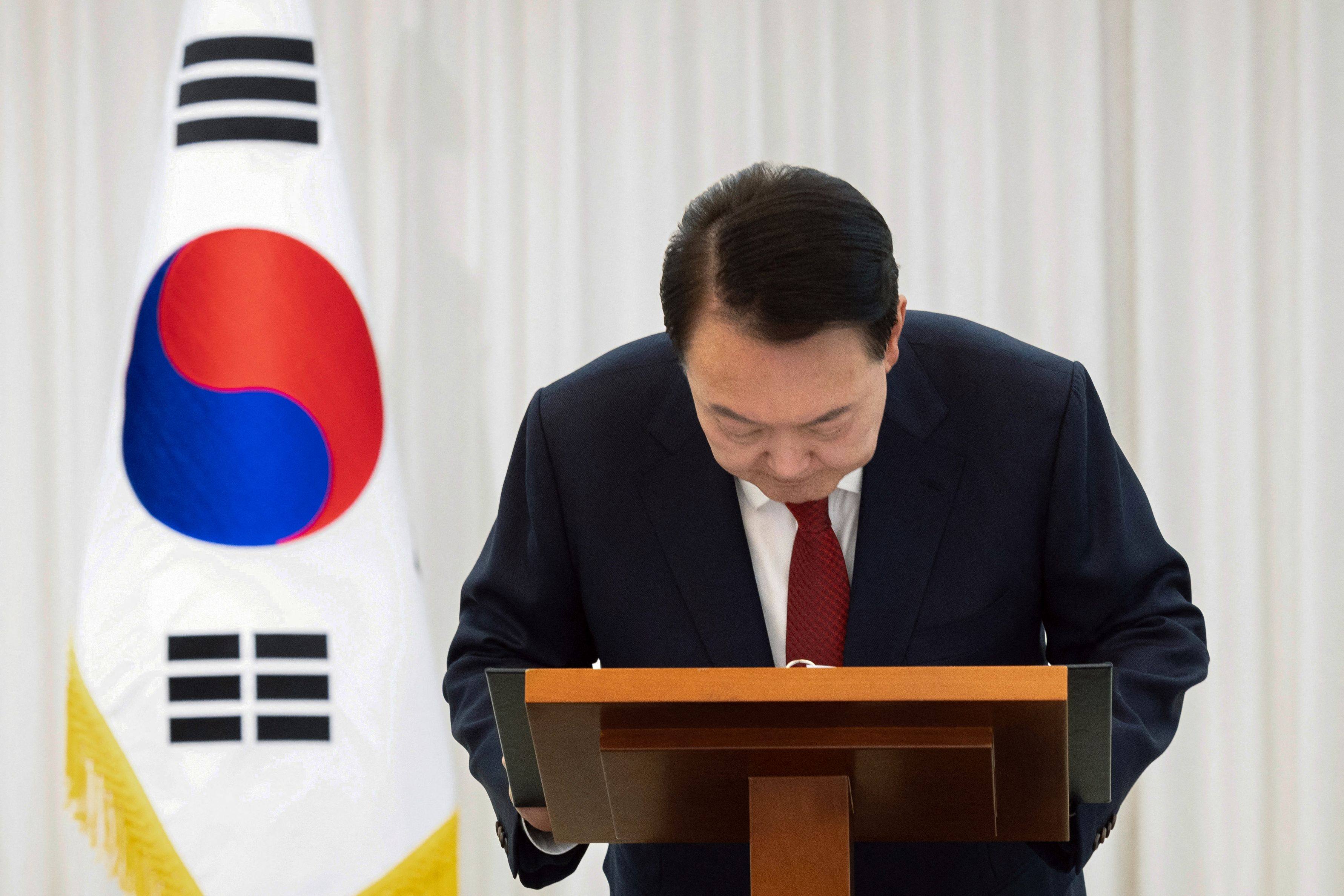 South Korean President Yoon Suk-yeol bows while giving a public address from his official residence in Seoul on Saturday. Yoon said he would “step aside” after parliament had voted to remove him from office. Photo: South Korean Presidential Office via Yonhap / AFP