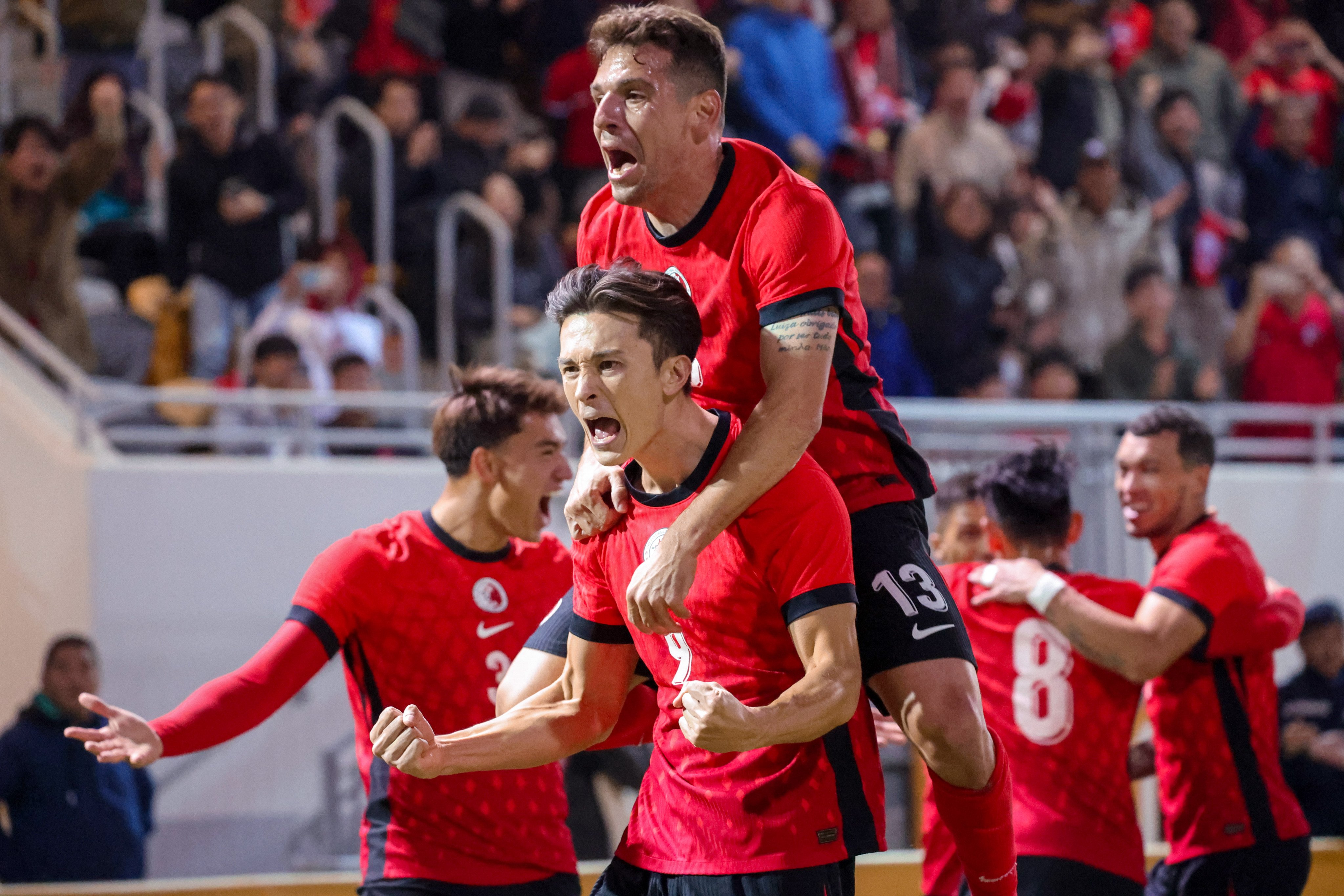 Hong Kong striker Matt Orr (left) and teammate Stefan Pereira celebrate Orr’s goal against Chinese Taipei. Photo: Dickson Lee