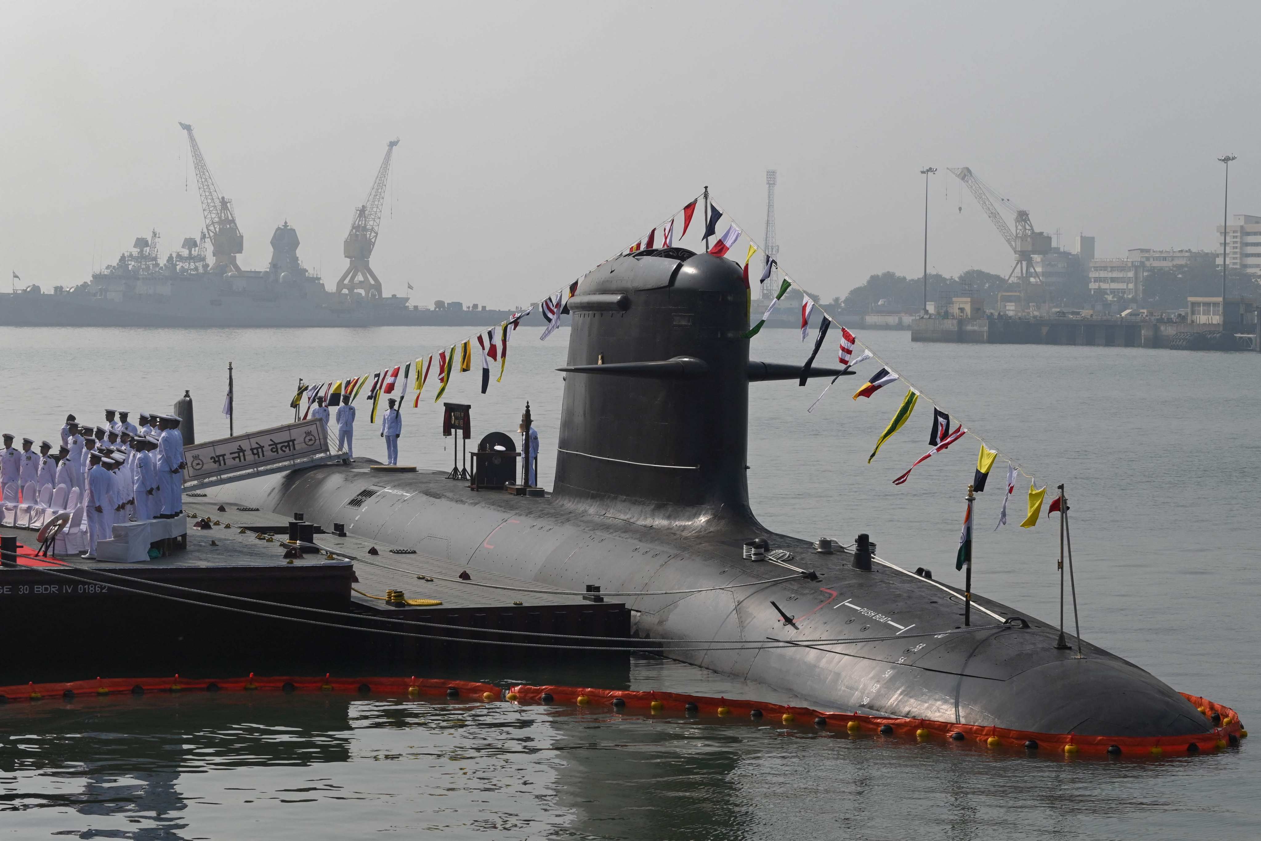 Indian navy sailors salute on board a submarine during its commissioning ceremony in 2021. Photo: AFP