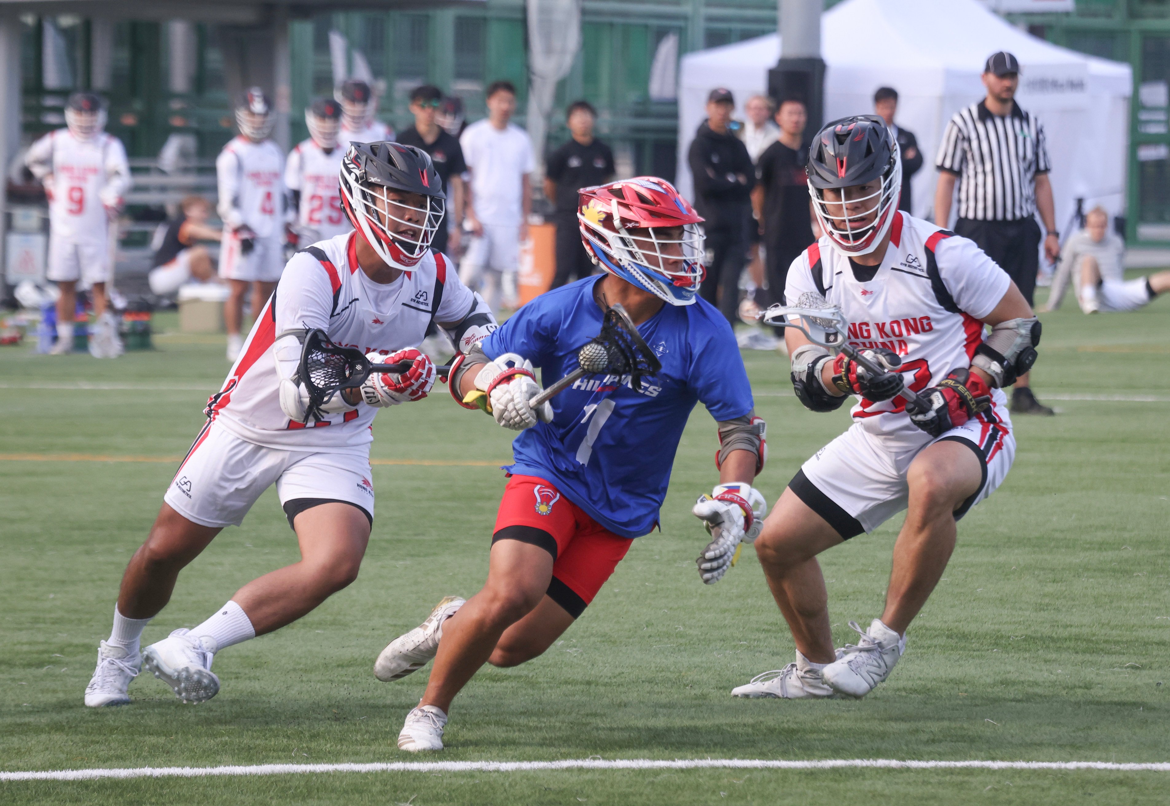 The Philippines’ Chase Ladrido (centre) is  flanked by Hong Kong’s Cheung Wing (left) and Lo Tin-chiu in the Filipinos’ 20-8 win at Wong Chuk Hang Sports Ground on Saturday. Photo: Jonathan Wong