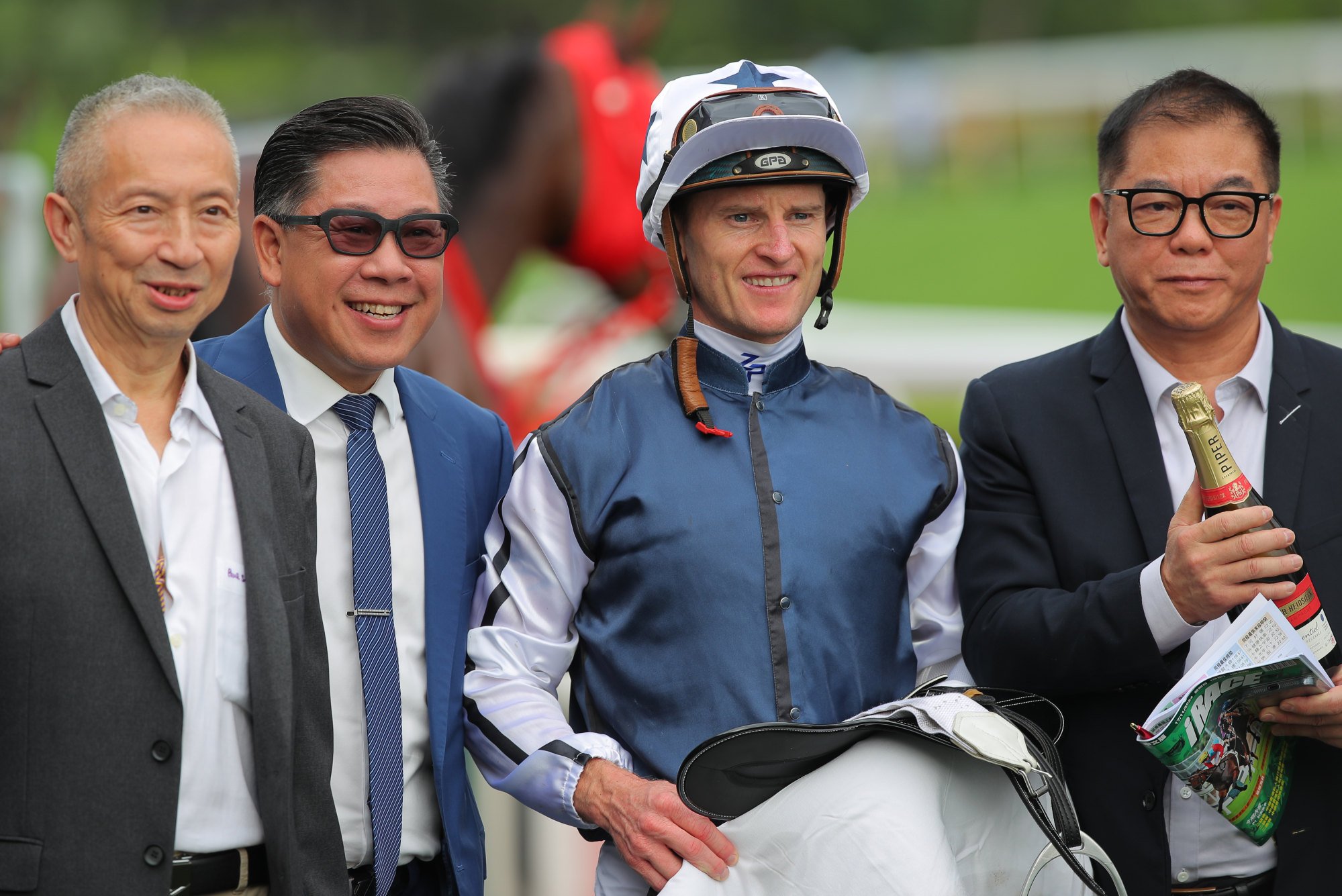 Trainer Dennis Yip (second from left), jockey Zac Purton and connections of Fast Network celebrate.