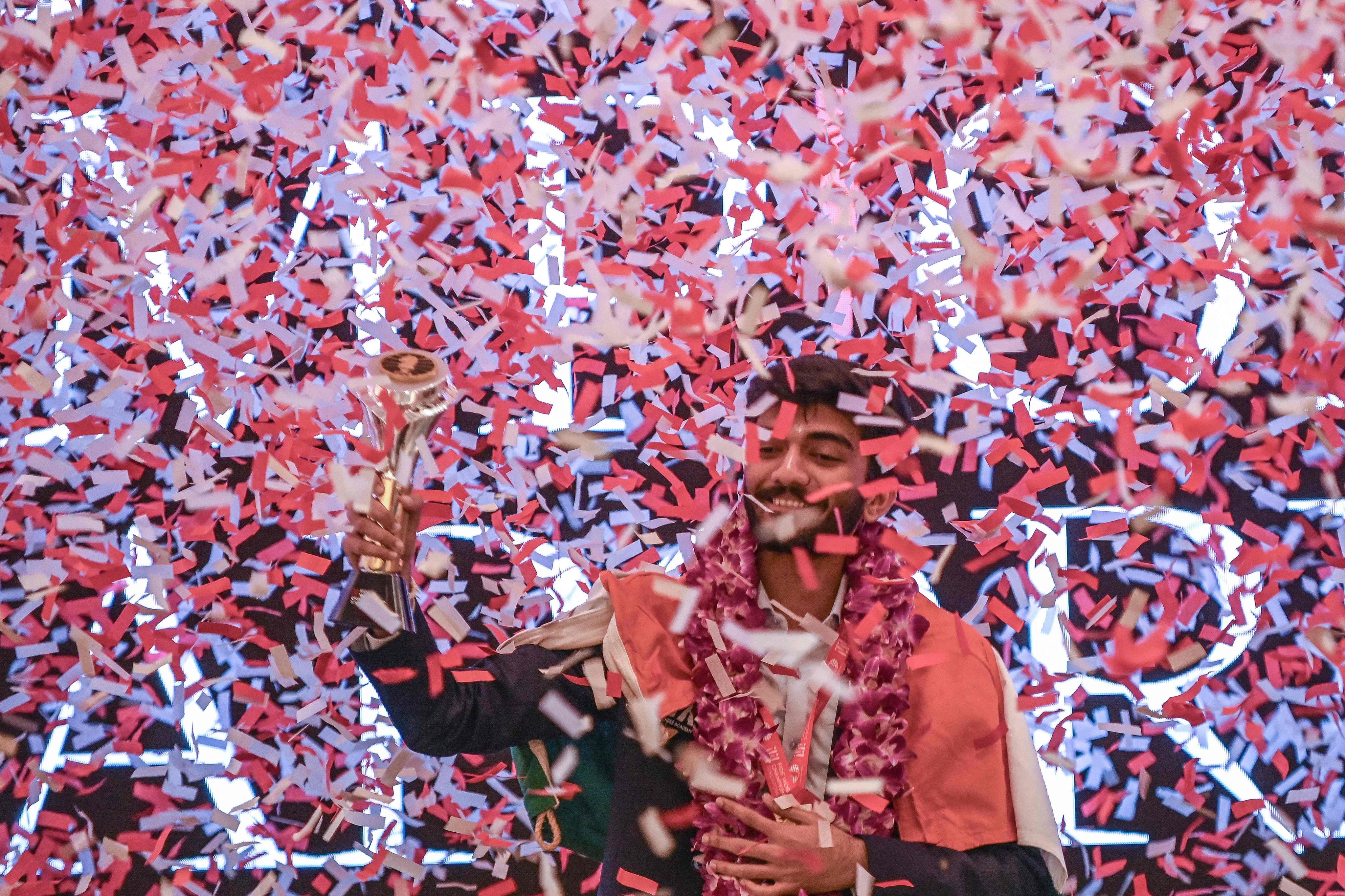 India’s Gukesh Dommaraju celebrates with the World Chess Championship 2024 trophy after beating China’s Ding Liren in Singapore on Friday. Photo: AFP