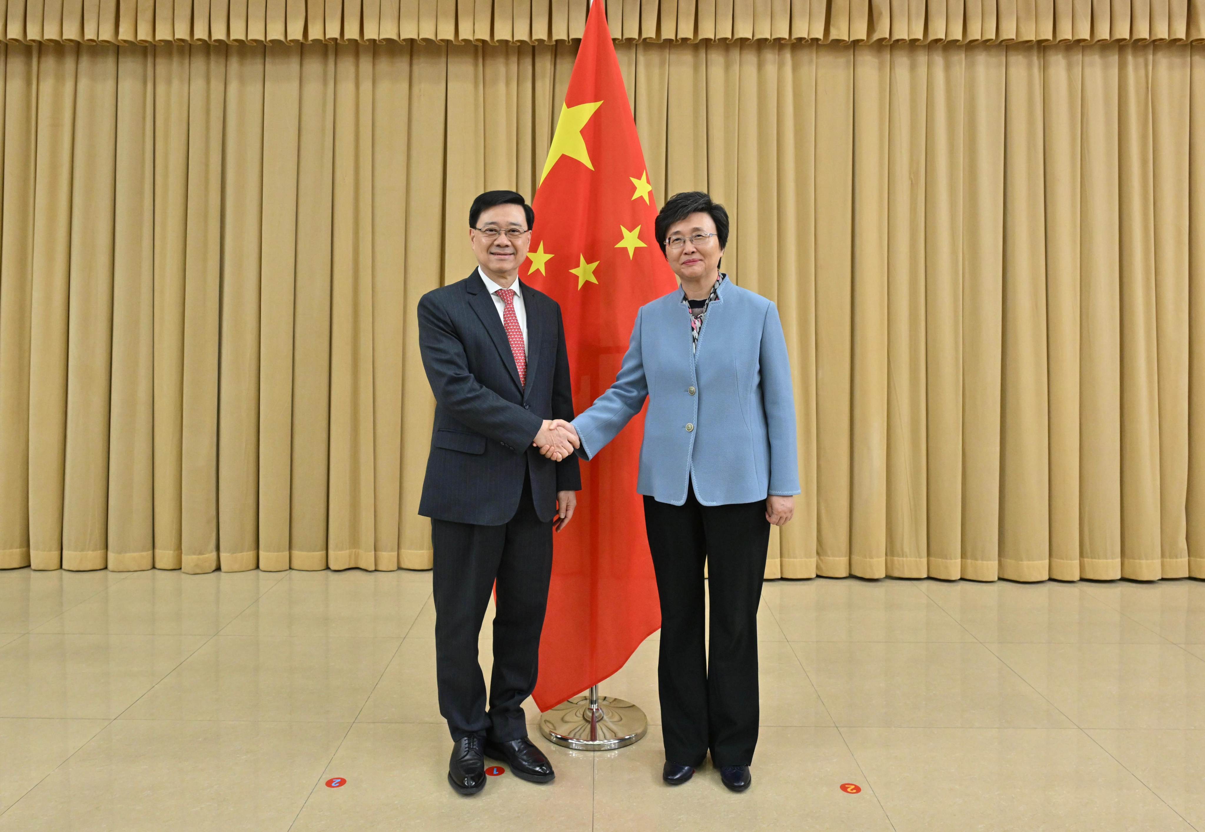 Chief Executive John Lee (left) with the country’s human resources and social security minister, Wang Xiaoping, during a meeting on Saturday in Beijing. Photo: Handout