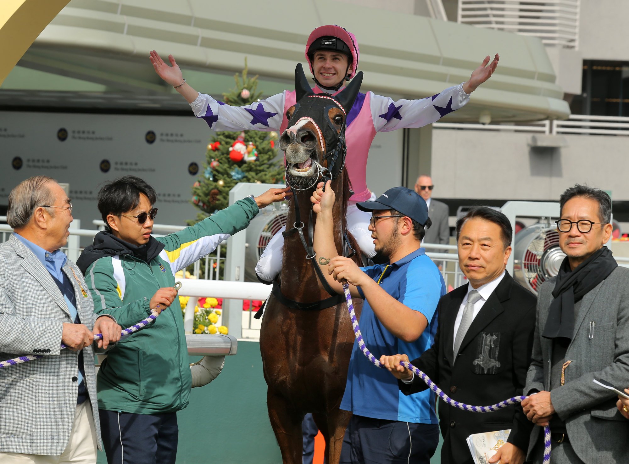 Alexis Pouchin soaks up his first Hong Kong success with trainer Ricky Yiu (second from left) and connections.