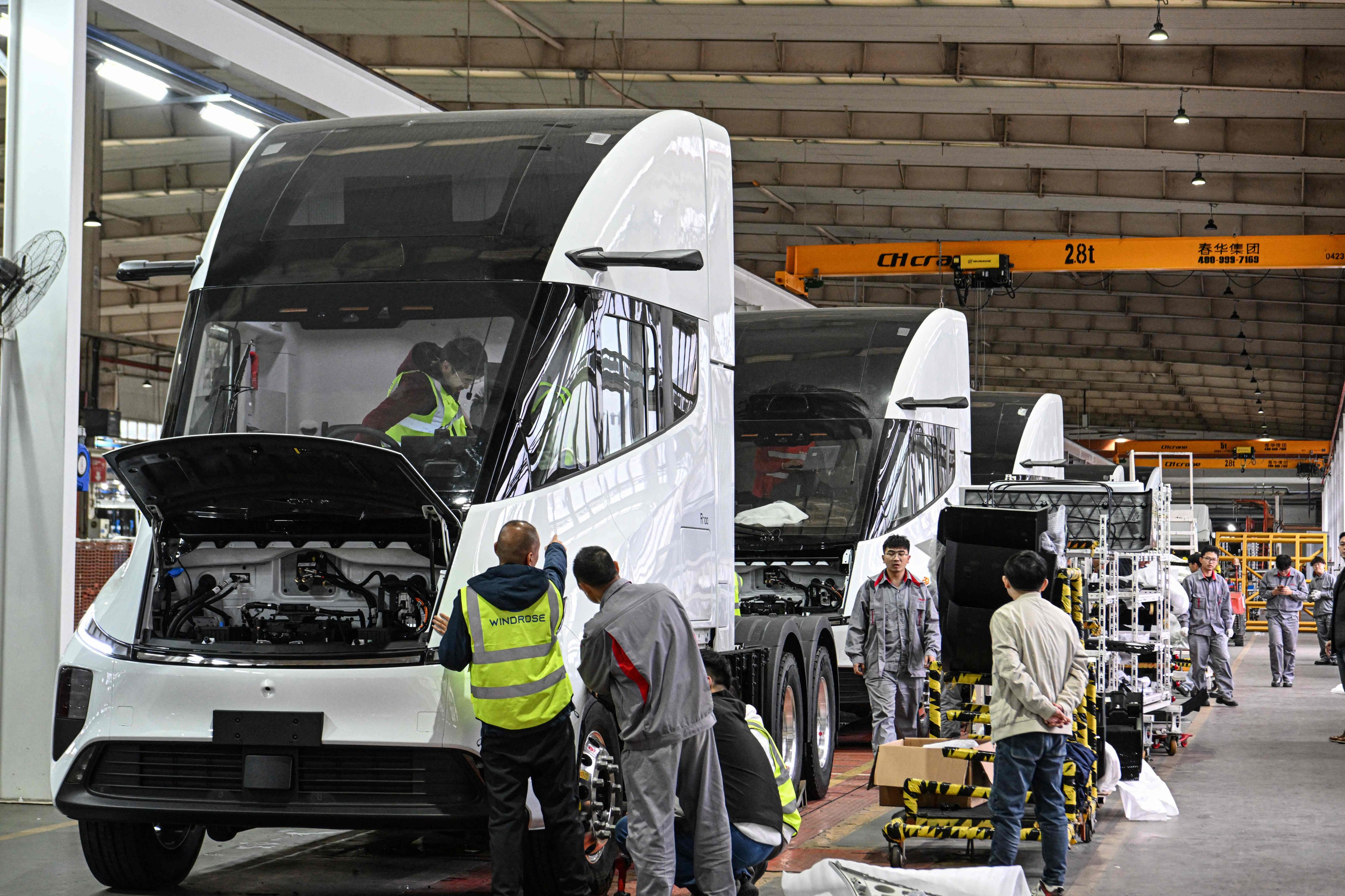 Employees of Chinese electric truck start-up Windrose assemble vehicles at a factory in Suzhou, in eastern Jiangsu province. Photo: AFP