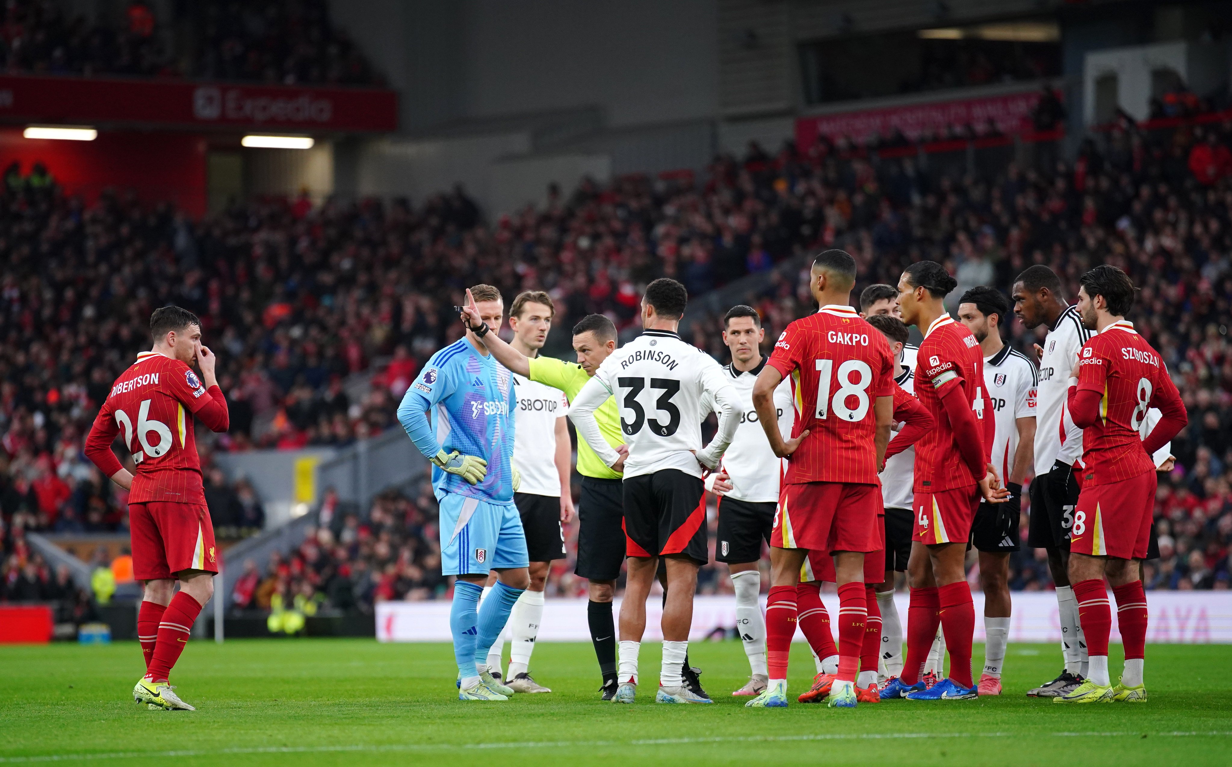 Liverpool were reduced to 10 men early during their clash with Fulham as Andy Robertson (left) was given his marching orders for preventing a goalscoring opportunity. Photo: dpa