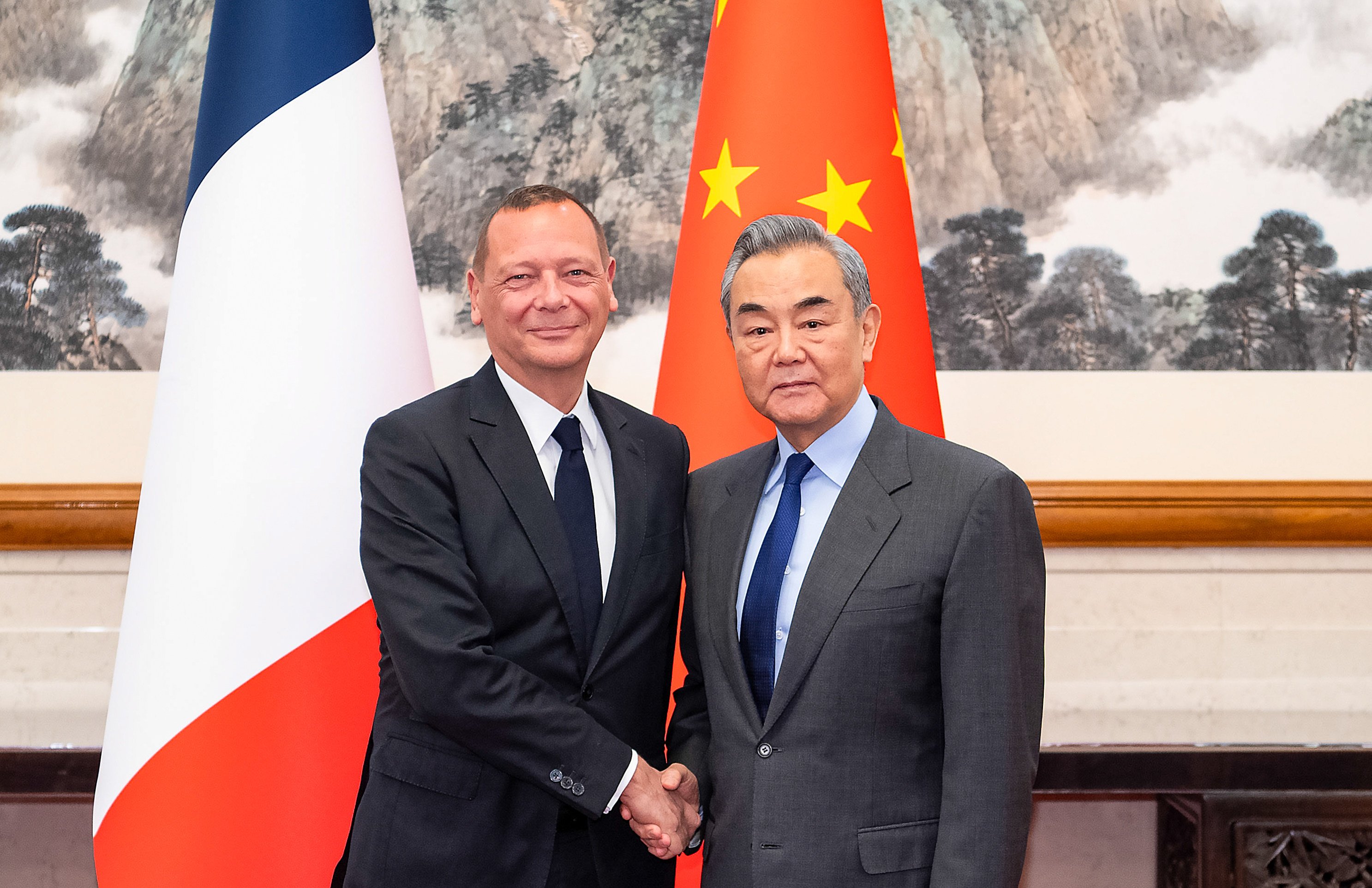 Chinese Foreign Minister Wang Yi (right) meets Emmanuel Bonne, diplomatic adviser to the French president, in Beijing on Saturday. Photo: Xinhua