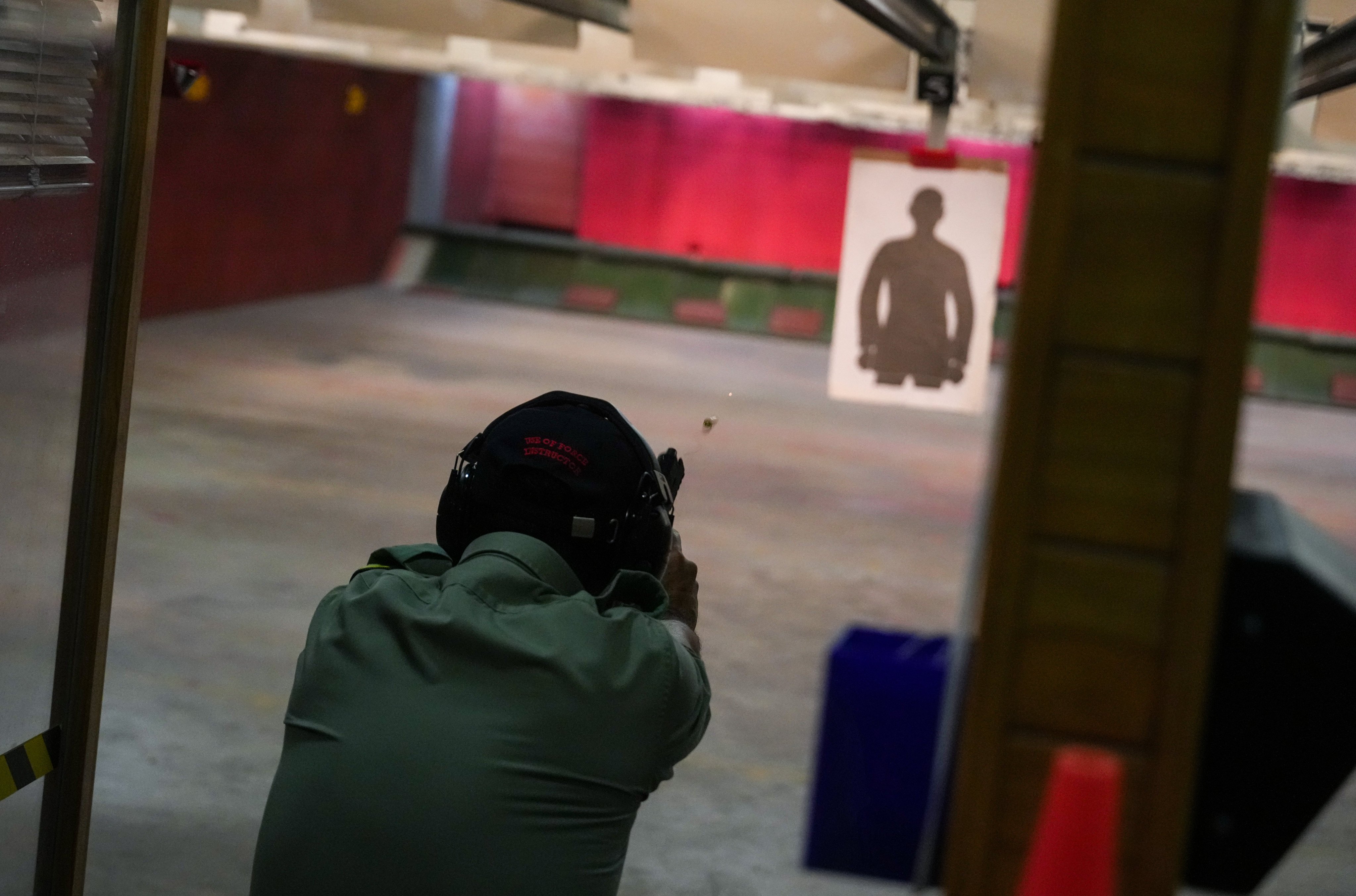 An officer fires a pistol at the Police College’s indoor range in Wong Chuk Hang. Photo: Sam Tsang