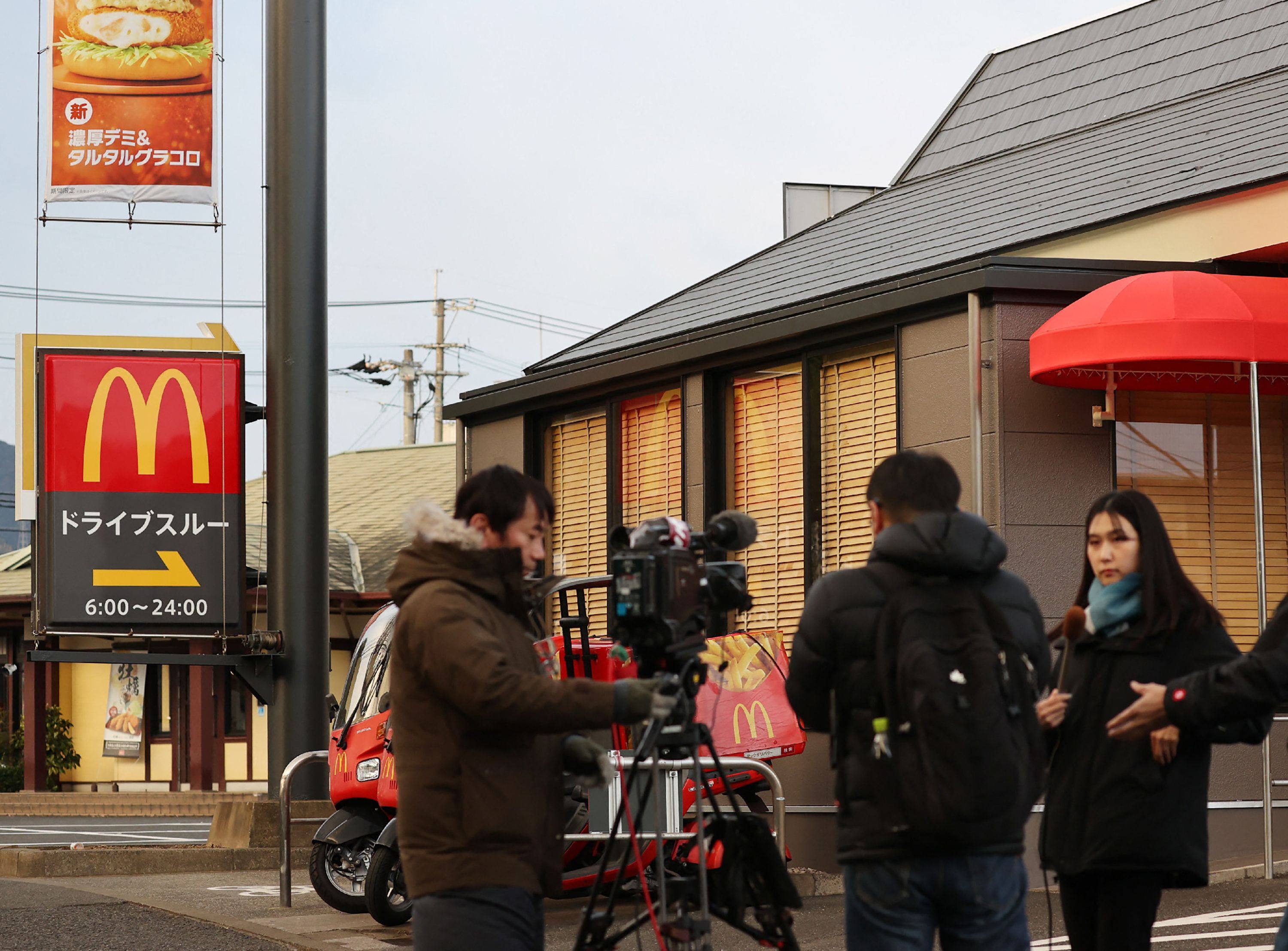 Reporters gather in front of the McDonald’s branch in Kitakyushu city, Fukuoka prefecture, where a schoolgirl was stabbed to death. Photo: Jiji Press/AFP