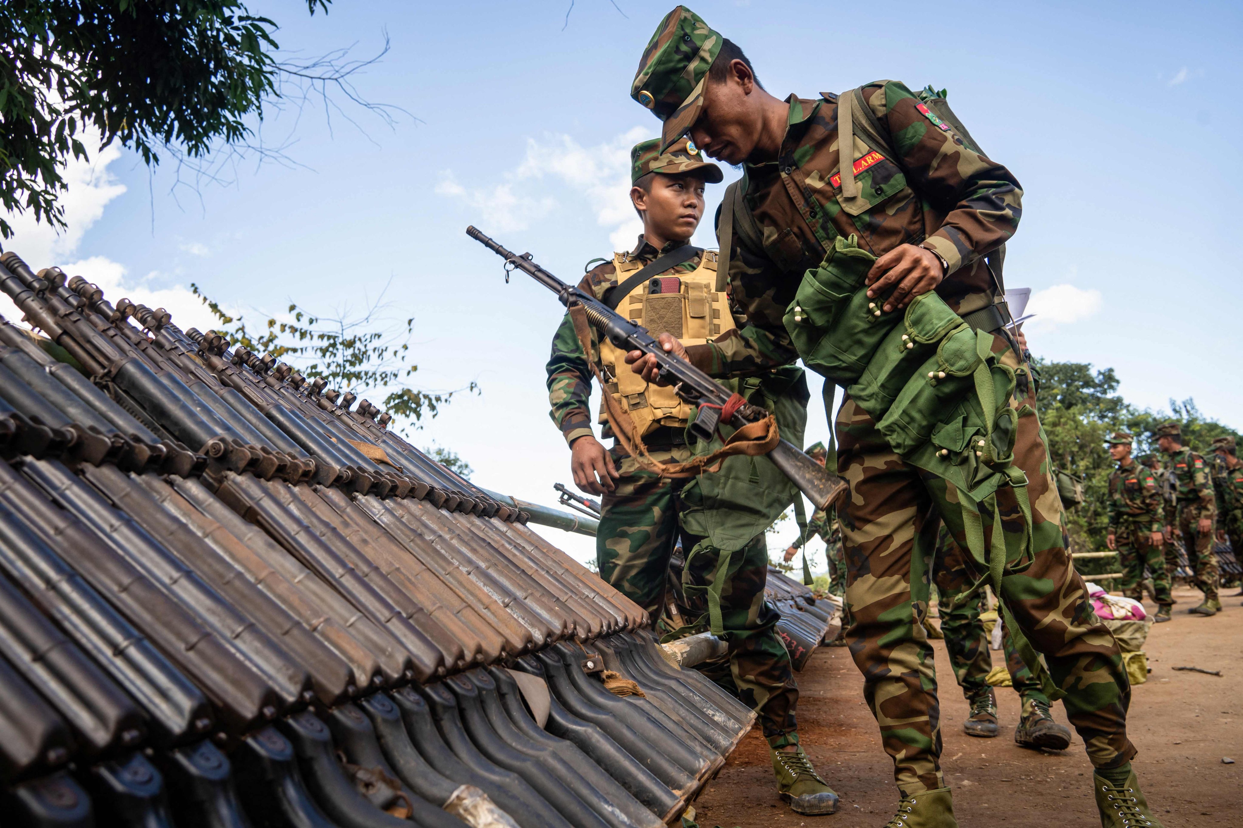 Members of Ta’ang National Liberation Army (TNLA) receiving military equipment in a secret jungle near Namhkam, Myanmar’s northern Shan State. Photo: AFP