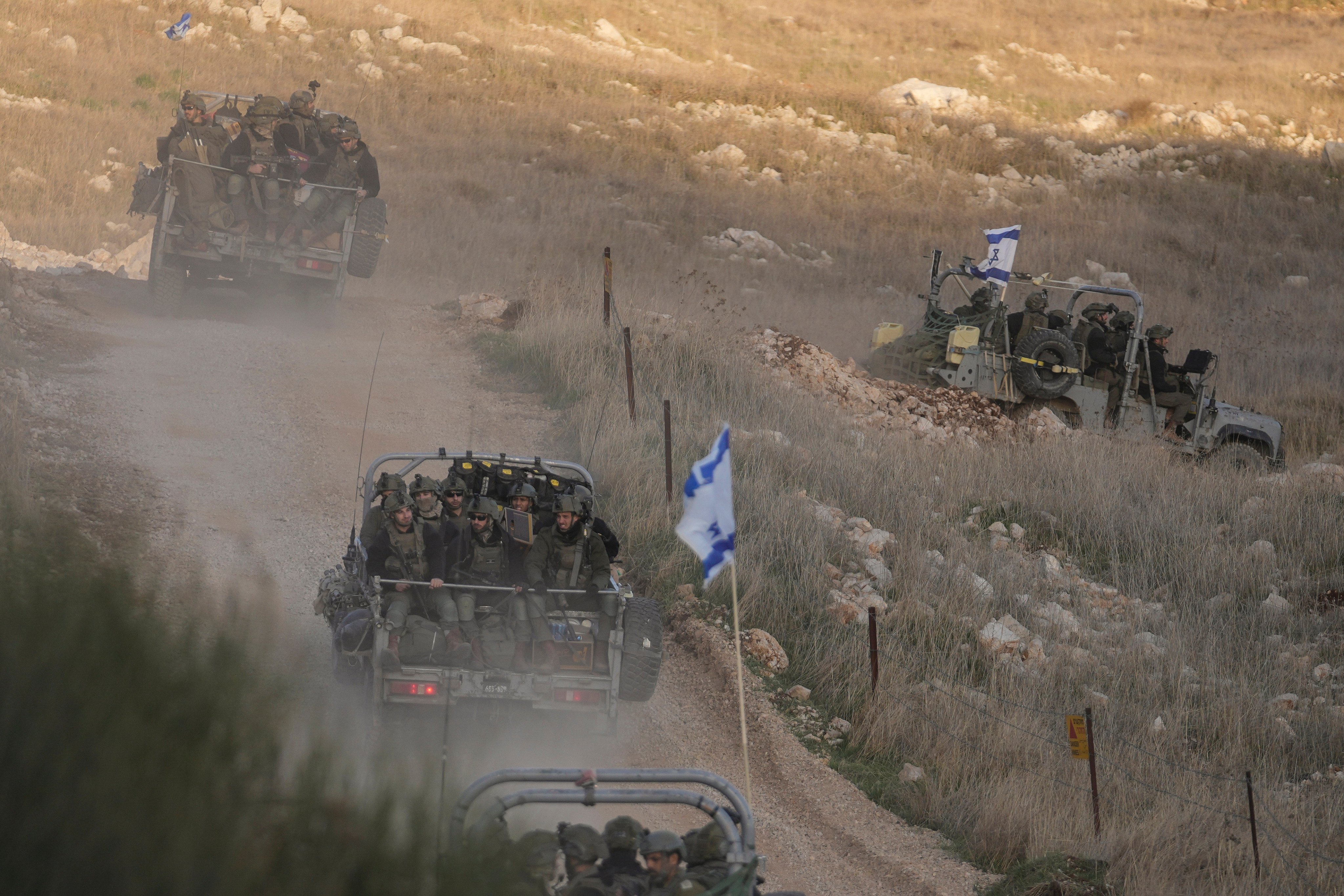 Israeli soldiers cross the security fence moving towards the so-called Alpha Line that separates the Israeli-annexed Golan Heights from Syria. Photo: AP