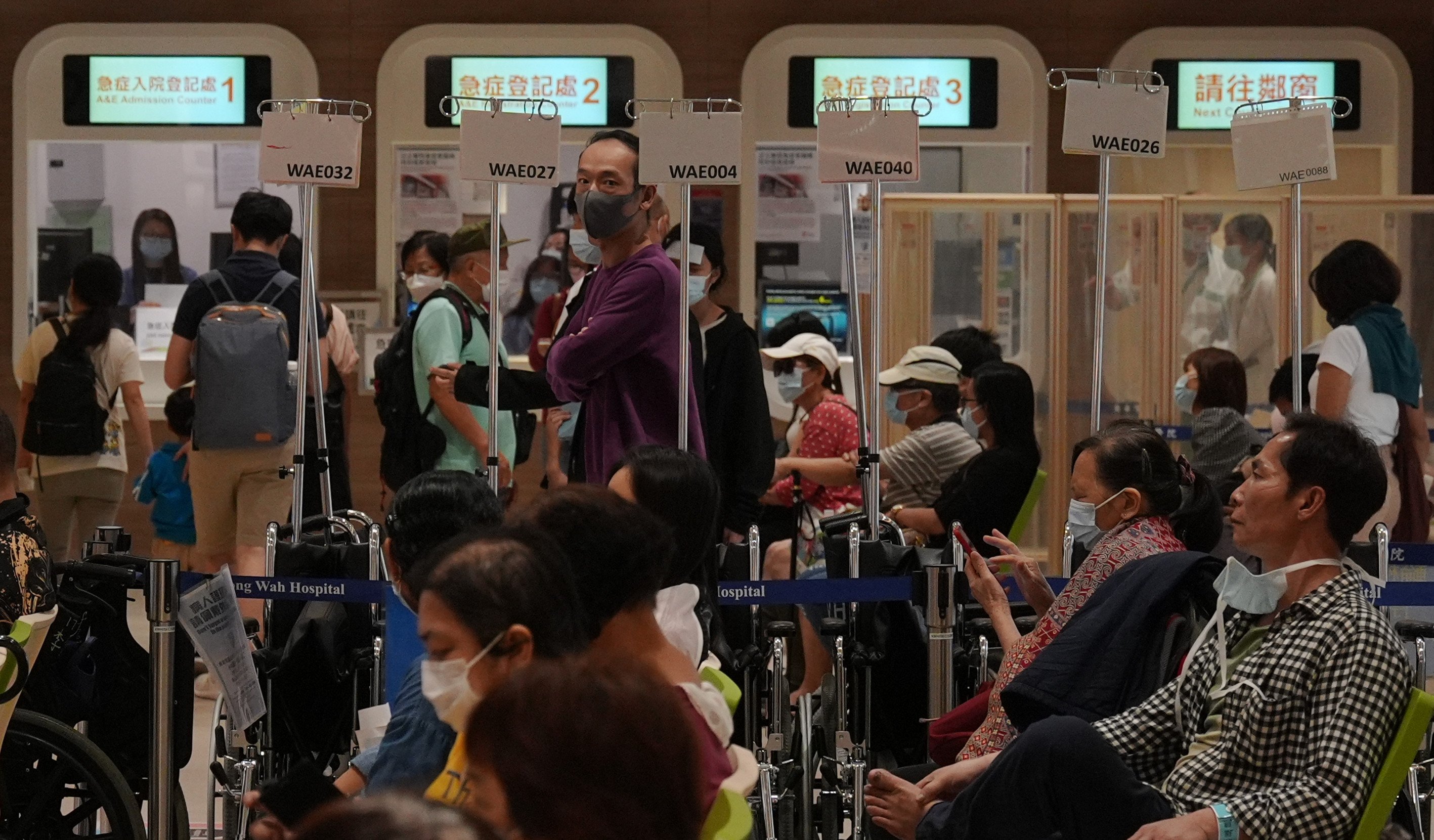 People wait at A & E in Kwong Wah Hospital on March 31. While Hong Kong faces a shortage of doctors, increasing their number alone may not resolve systemic issues such as resource distribution and public-private imbalance. Photo: Eugene Lee 
