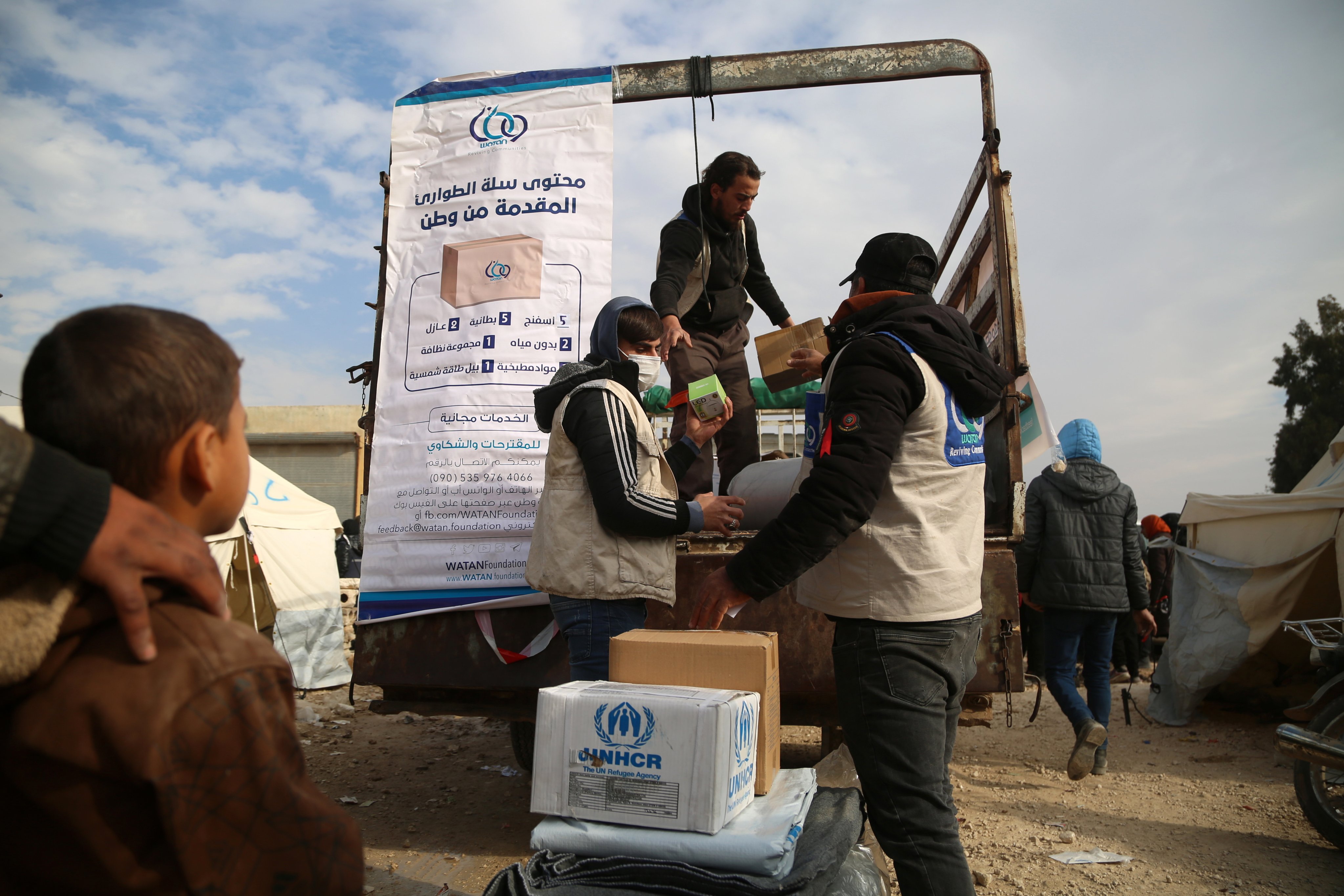 Displaced families collect aid provided by the United Nations at a refugee camp in the town of Al-Bardaqli, northern Syria. On Sunday, the UK said it would release US$63 million in aid for the ‘most vulnerable’ Syrians and for those in need in neighbouring Lebanon and Jordan. Photo: EPA-EFE