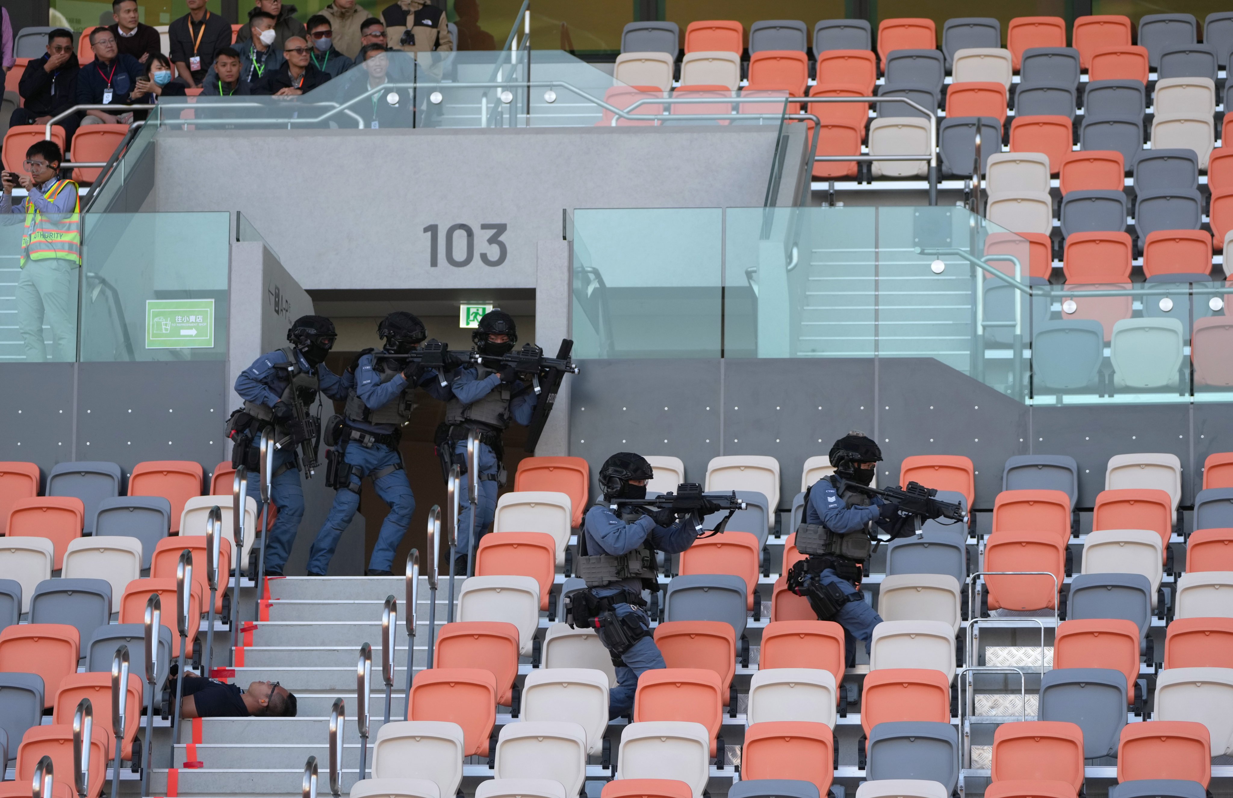 Officers storm the 5,000-seat stadium as part of the drill. Photo: Sam Tsang