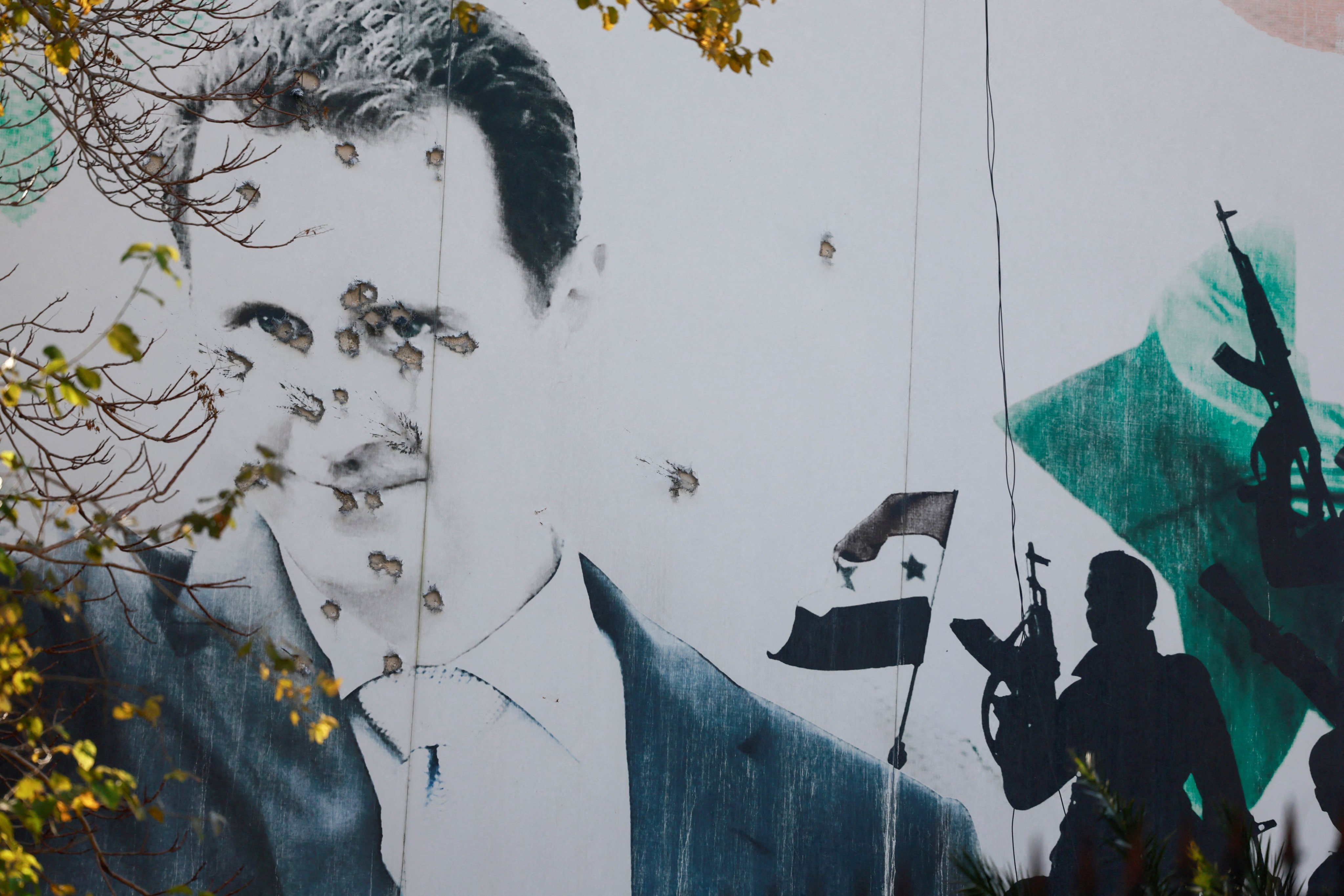 A billboard in Damascus with a picture of Syria’s Bashar al-Assad shows damage by bullet holes. Photo: Reuters