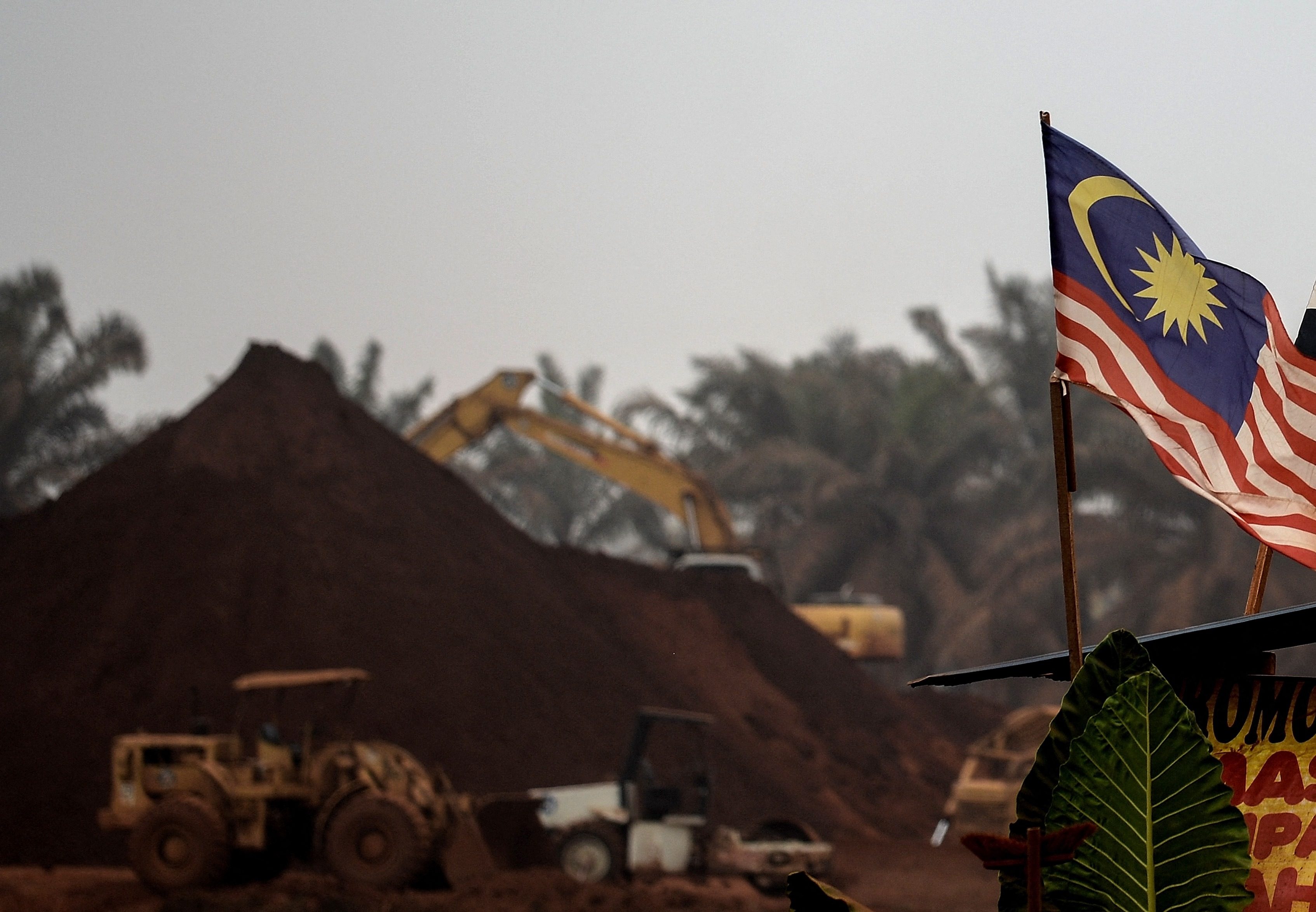 A Malaysian flag flies at the entry-point to a mining site in rural Pahang state in 2015. Photo: AFP