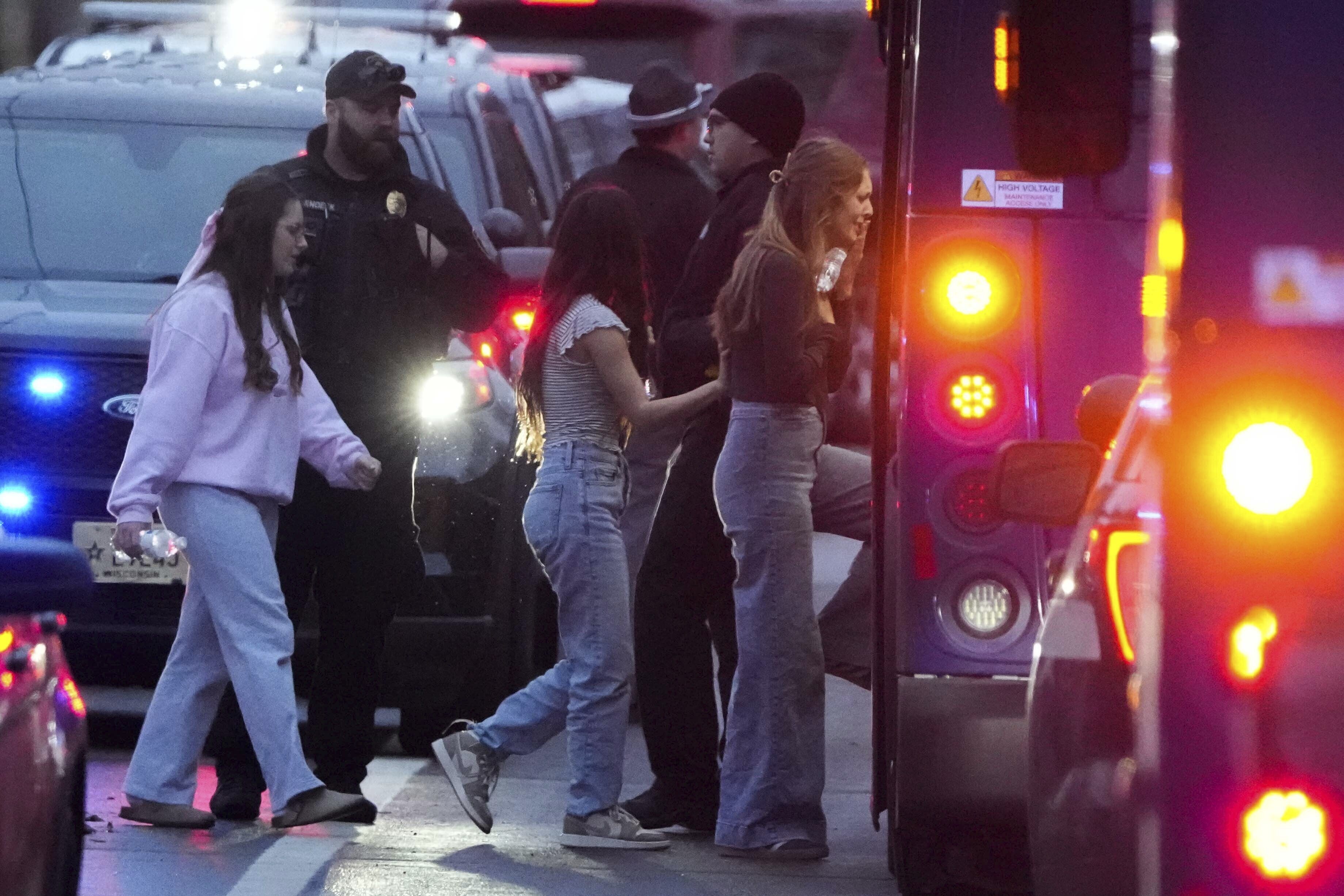 Students aboard a bus as they leave a shelter following the shooting. Photo: AP