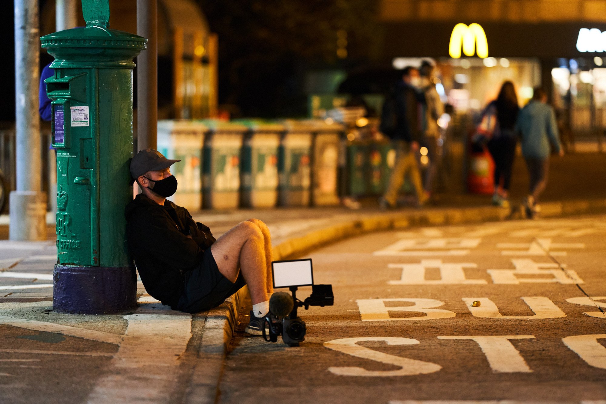 Four Trails director Robin Lee rests against a post box by the Mui Wo Ferry Pier in a still from the documentary about the 2021 Hong Kong Four Trails Ultra Challenge. Photo: Edko Films