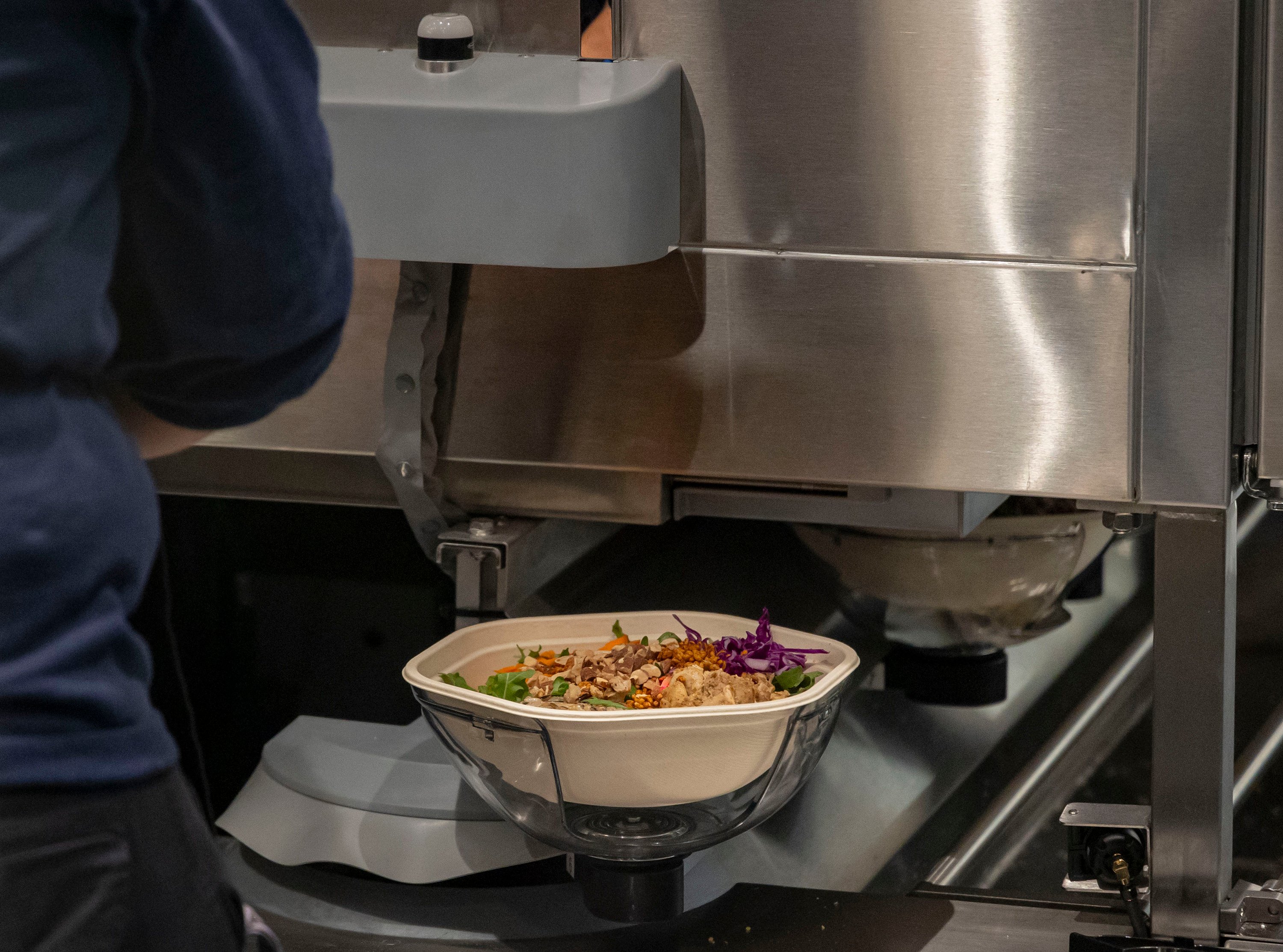 Salads come off the new Infinite Kitchen robotic system at a Sweetgreen restaurant in Chicago. The US chain is committed to rolling out automated kitchens where robots make the salads. Photo: TNS