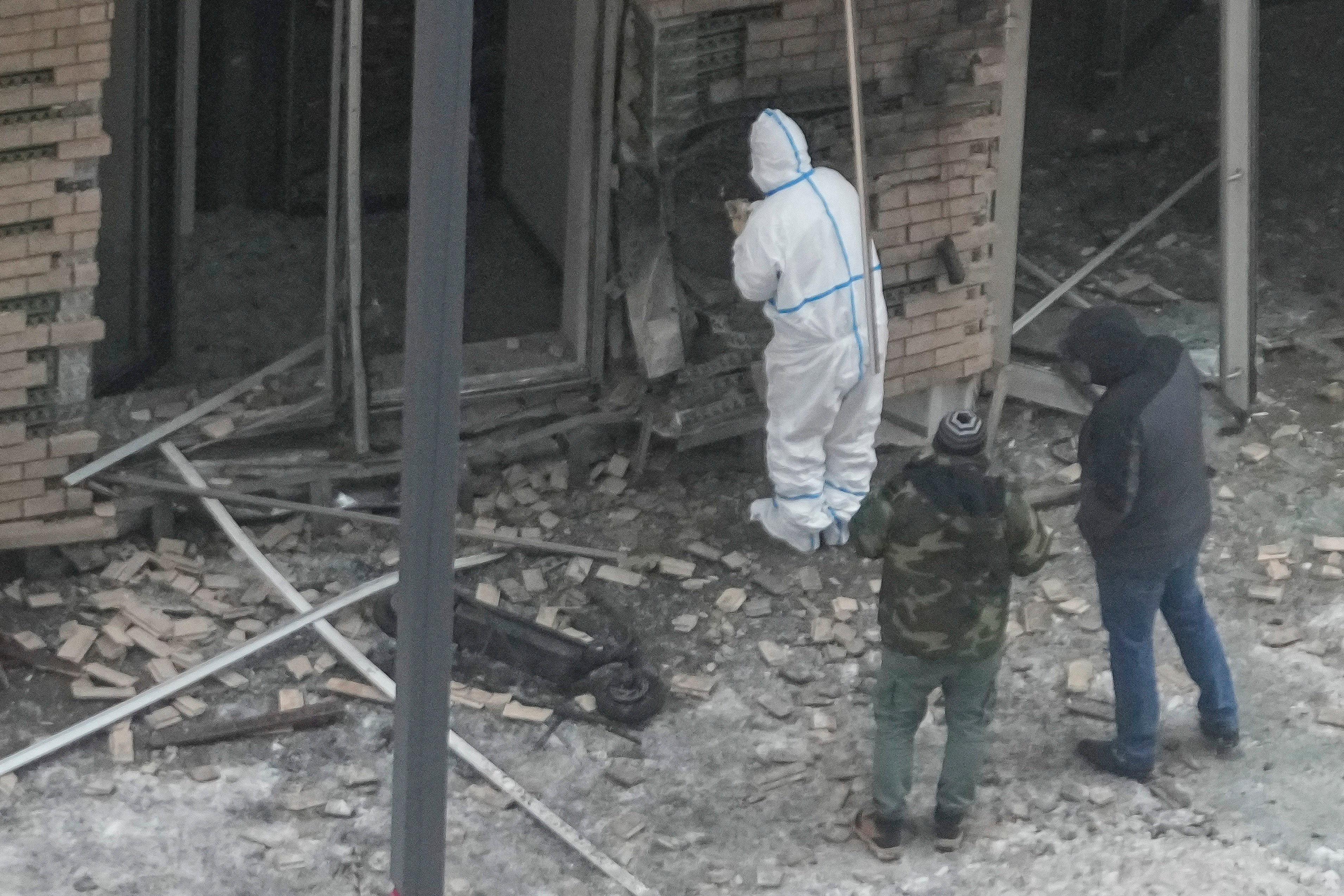 Investigators near a destroyed scooter at the scene on Tuesday. Photo: AP