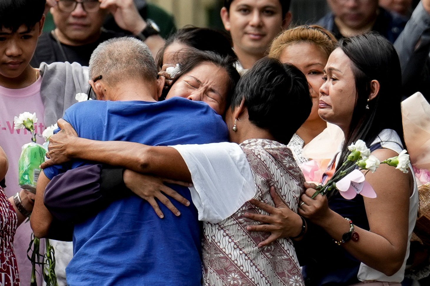 Mary Jane Veloso (centre) is embraced by her parents inside a correctional facility in the Philippines on Wednesday. Photo: Reuters