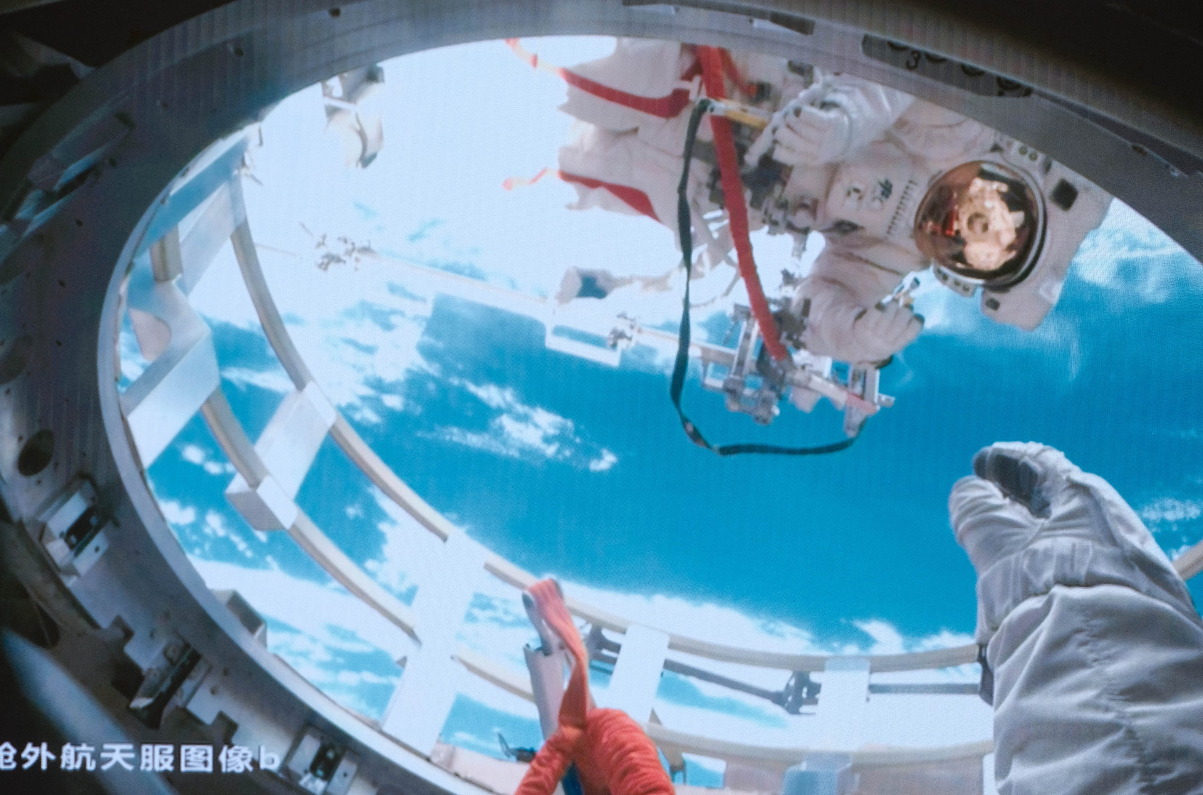 Shenzhou-19 astronaut Cai Xuzhe (above) and Song Lingdong (below) working outside and inside the airlock cabin of China’s orbiting space station, the Tiangong, on Tuesday. Photo: Xinhua