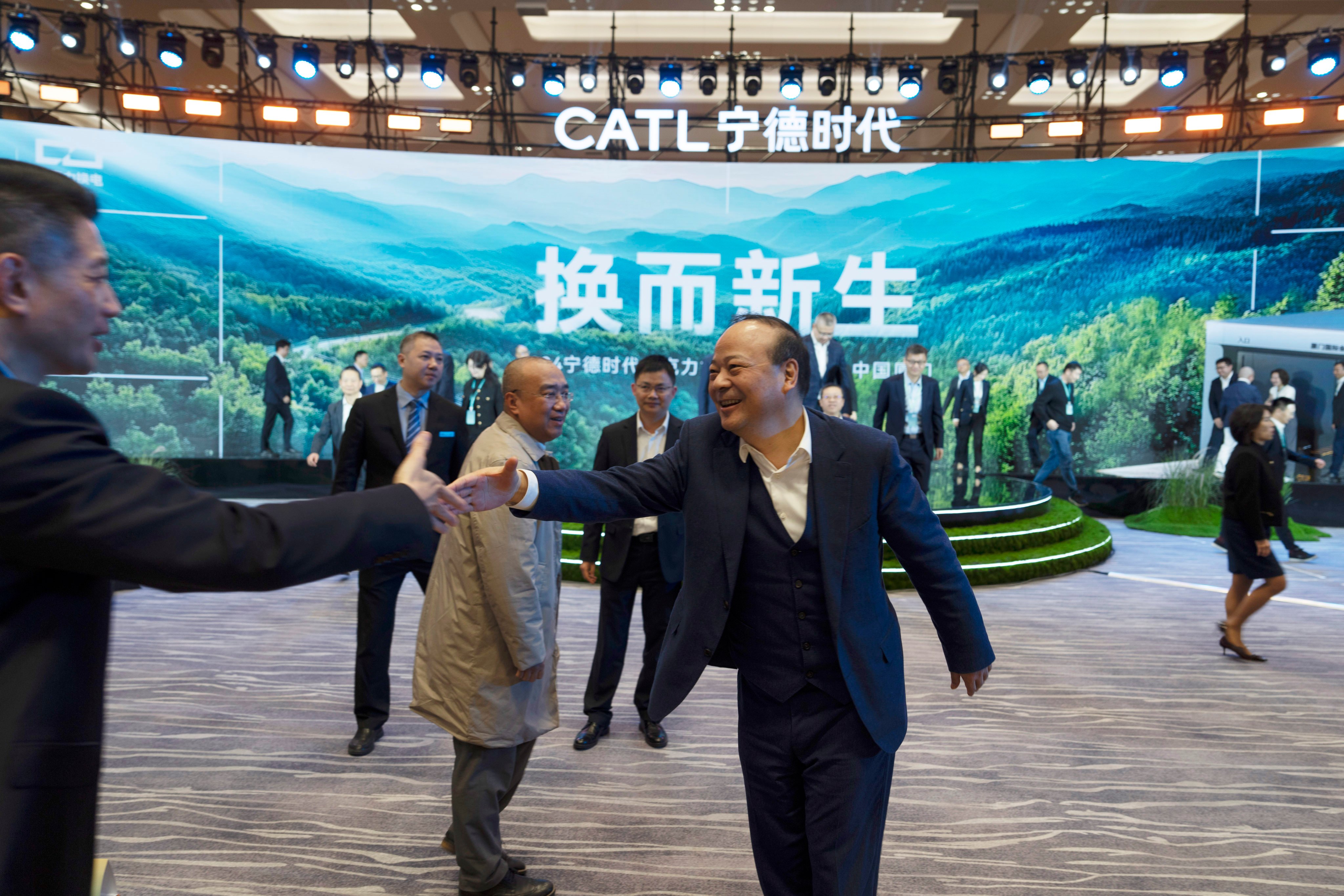 Robin Zeng, CEO of EV battery maker CATL, greets a guest after a launch event for the next generation of swap stations in Xiamen, Fujian province on December 18, 2024. AP Photo