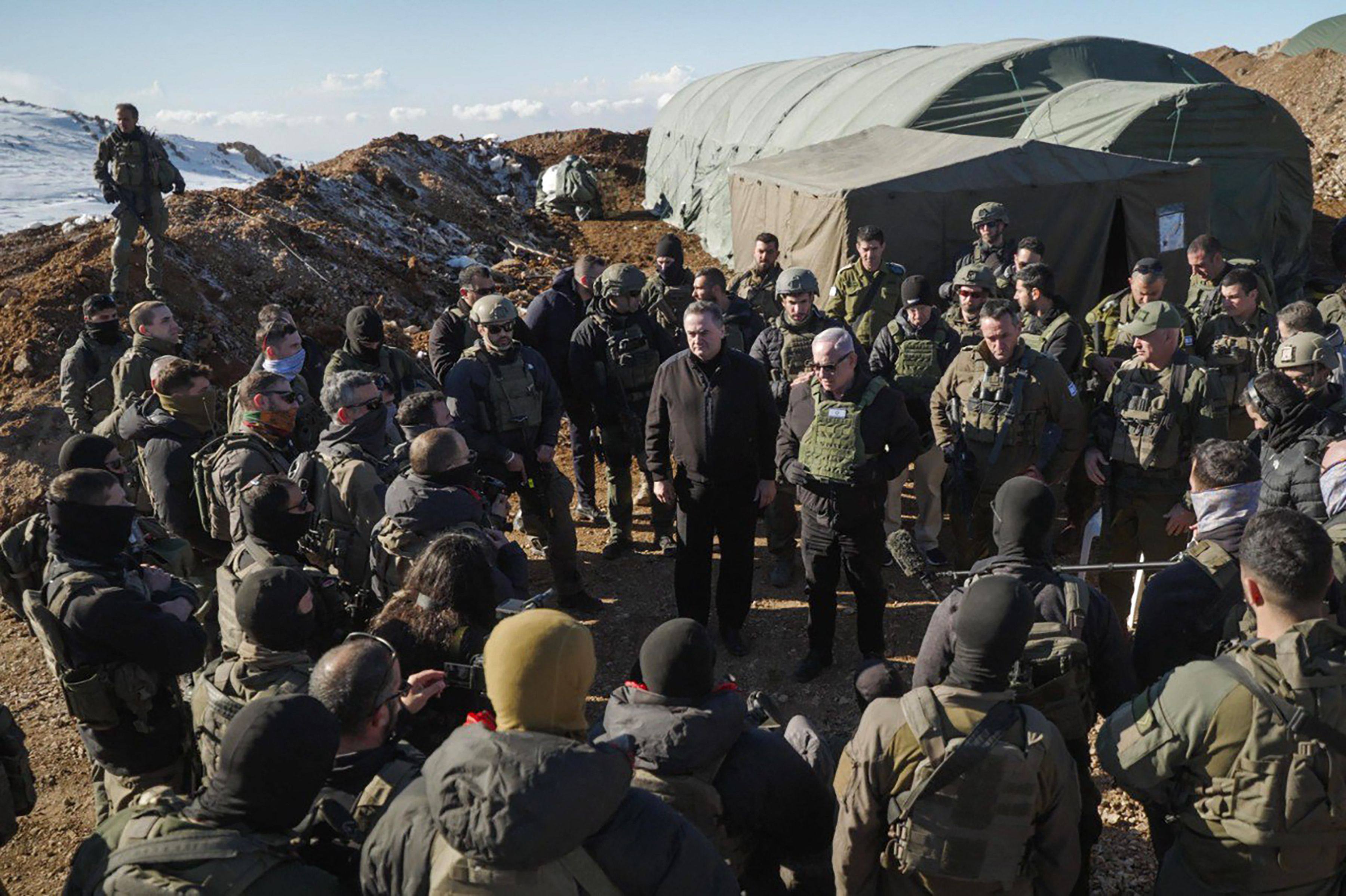 Israeli Prime Minister Benjamin Netanyahu and Defence Minister Israel Katz with members of the Israeli army at Mount Hermon in the annexed Golan Heights. Photo: GPG via AFP