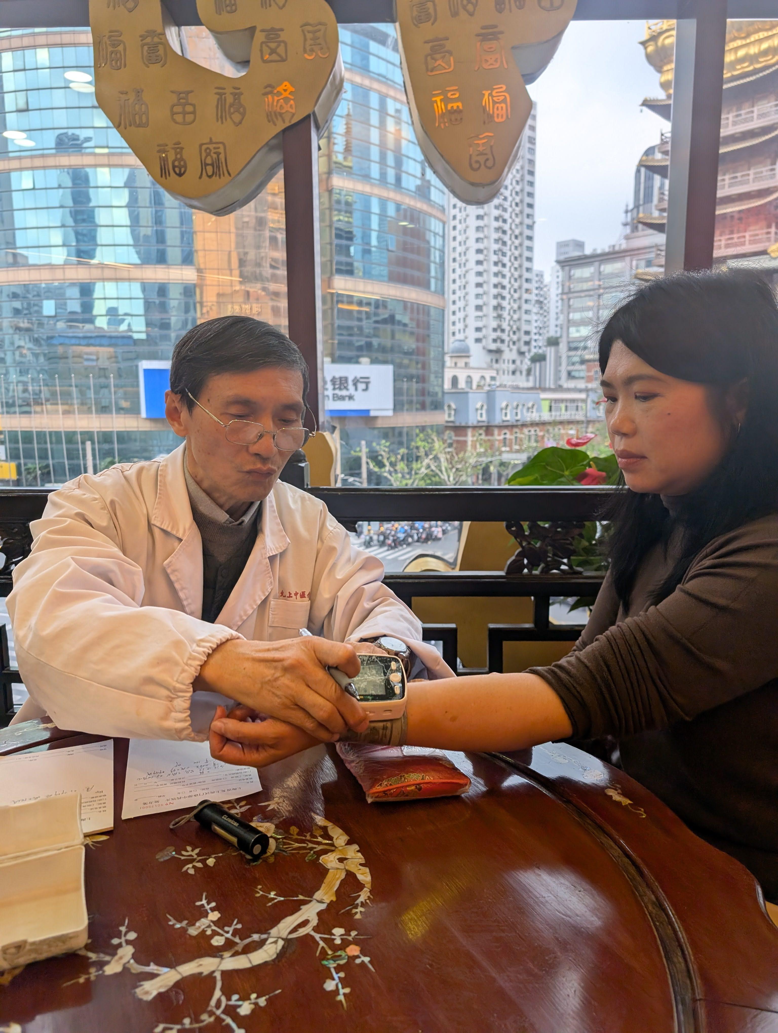 Qiu Jingchuan, deputy chief practitioner at Lei Yun Shang, takes a patient’s blood pressure at the company’s TCM clinic in Shanghai, China. Photo: Lisa Cam