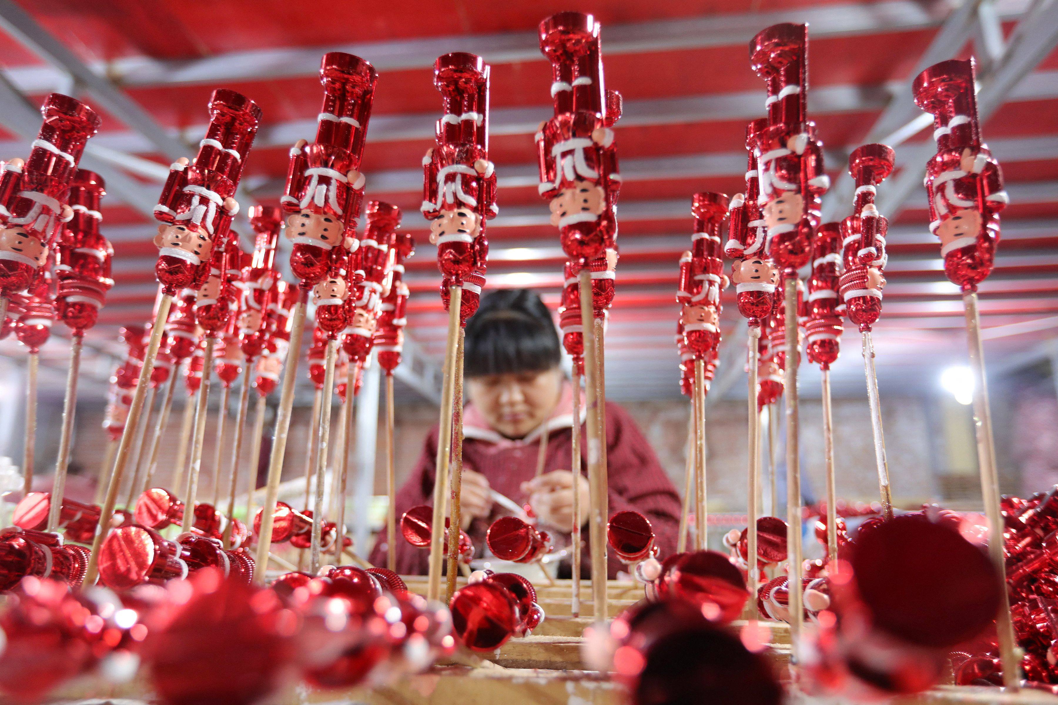 A worker makes Christmas decorations at a workshop in Huaibei, in China’s eastern Anhui province, on December 10. Photo: AFP