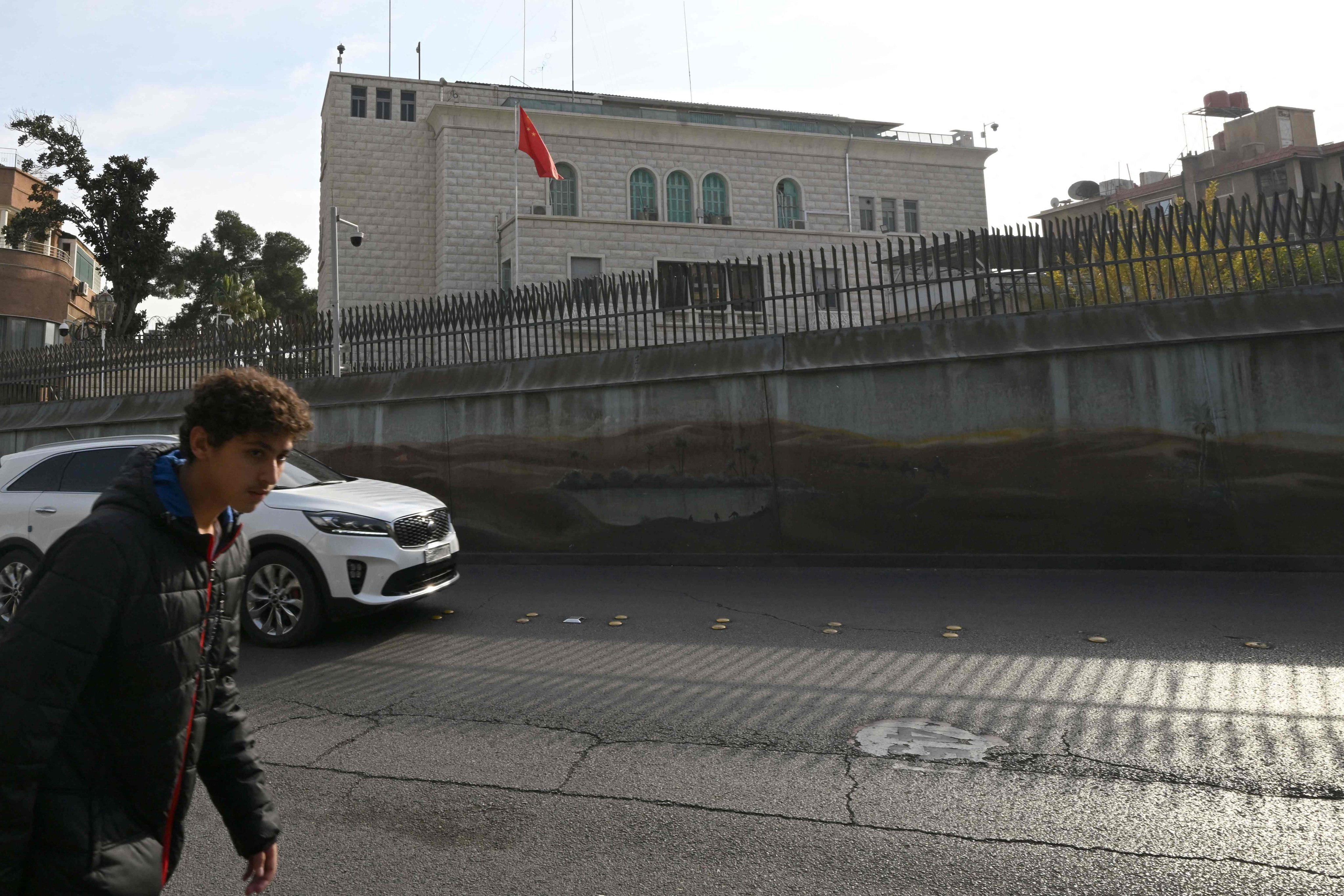 A man walks across from the embassy of China in the Syrian capital Damascus on December 12. Islamist-led rebels took Damascus in a lightning offensive on December 8, ousting Syrian president Bashar al-Assad and ending five decades of Baath rule in Syria. Photo: AFP