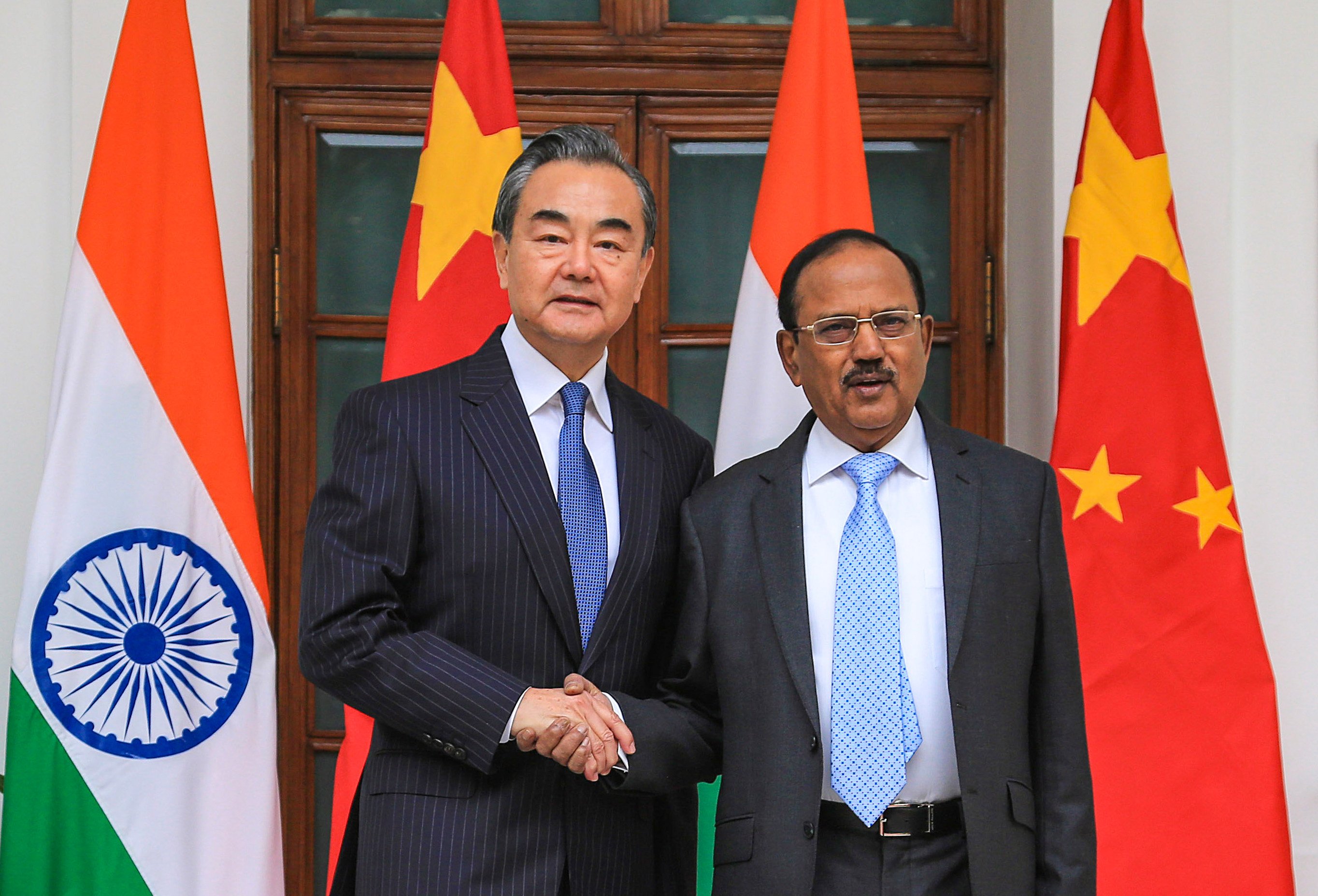 Chinese Foreign Minister Wang Yi (left) shakes hands with Indian National Security Adviser Ajit Doval in New Delhi during their December 2019 meeting on boundary issues – the last time talks were held under a high-level diplomatic mechanism that was halted after border clashes broke out in 2020. Photo: Xinhua