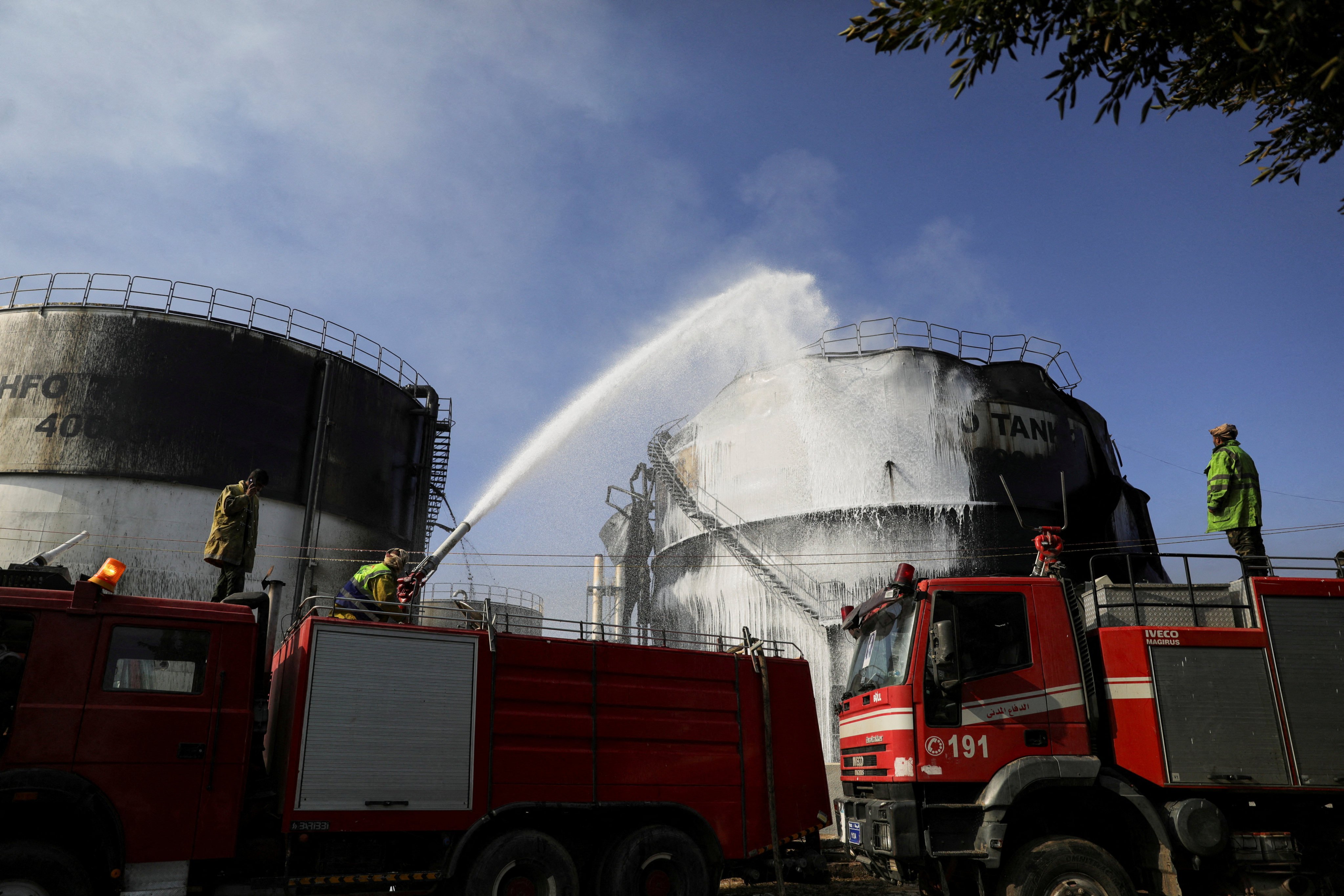 Firefighters extinguish a fire at a power station following Israeli air strikes in Sanaa, Yemen. Photo: Reuters