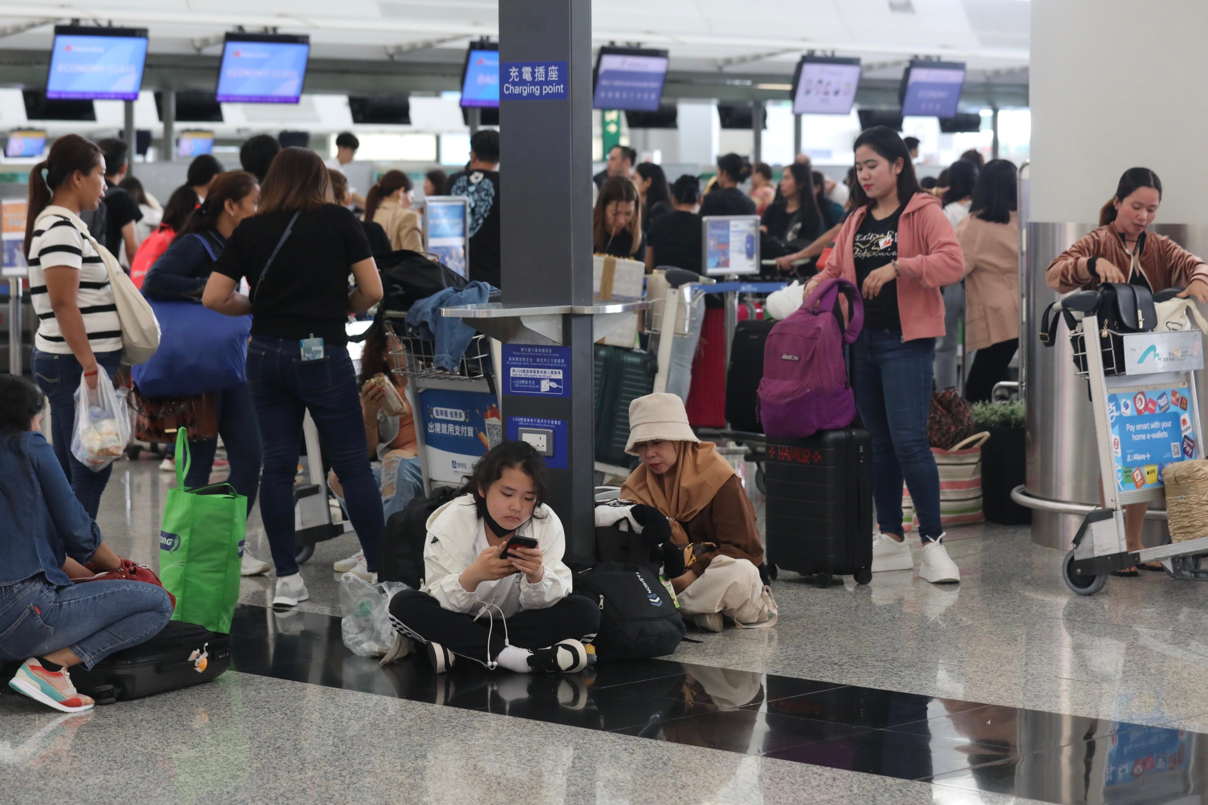 Passengers at Hong Kong International Airport on July 20, a day after a global IT service shortage affected air travel. Cybersecurity threats and extreme weather events are among the global risks that could become more severe in the coming years, contributing to financial woes across borders. Photo: Xiaomei Chen 
