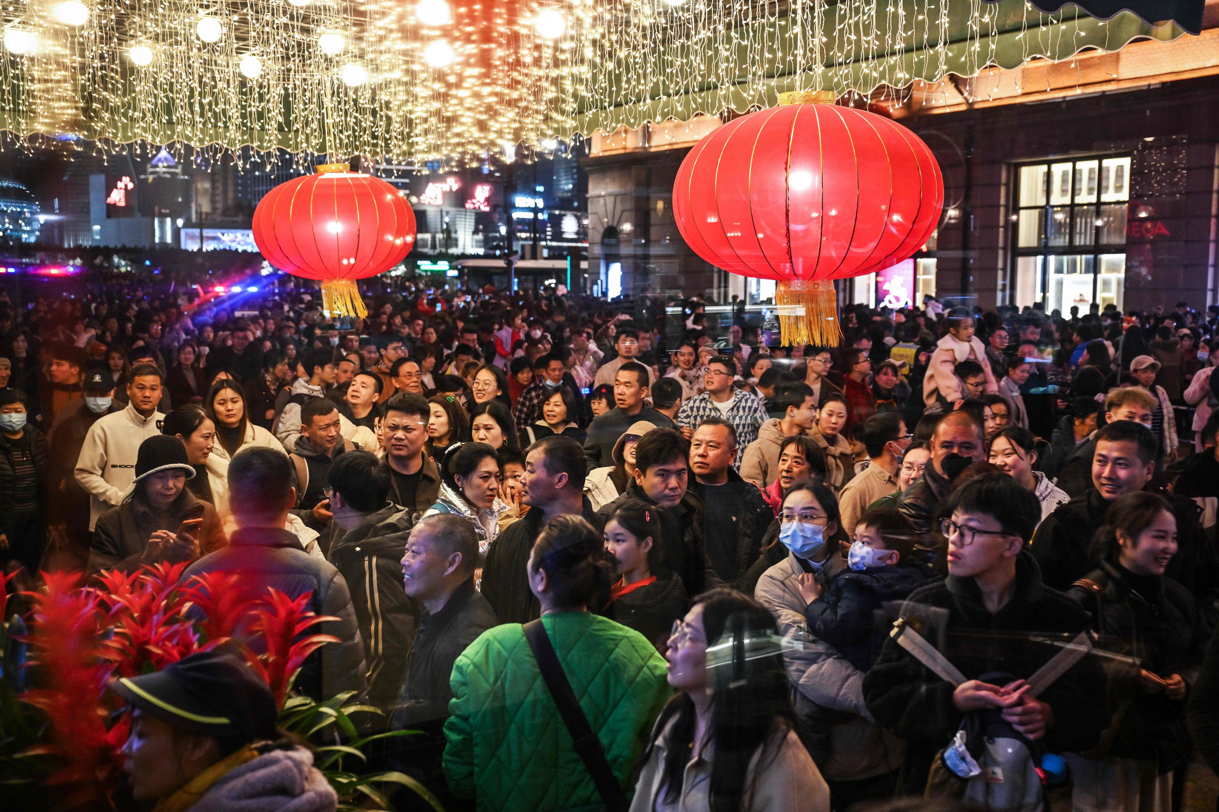 Crowds of people walk past the Peace Hotel on Shanghai’s Bund during the Lunar New Year holiday in February 2024. Photo: AFP