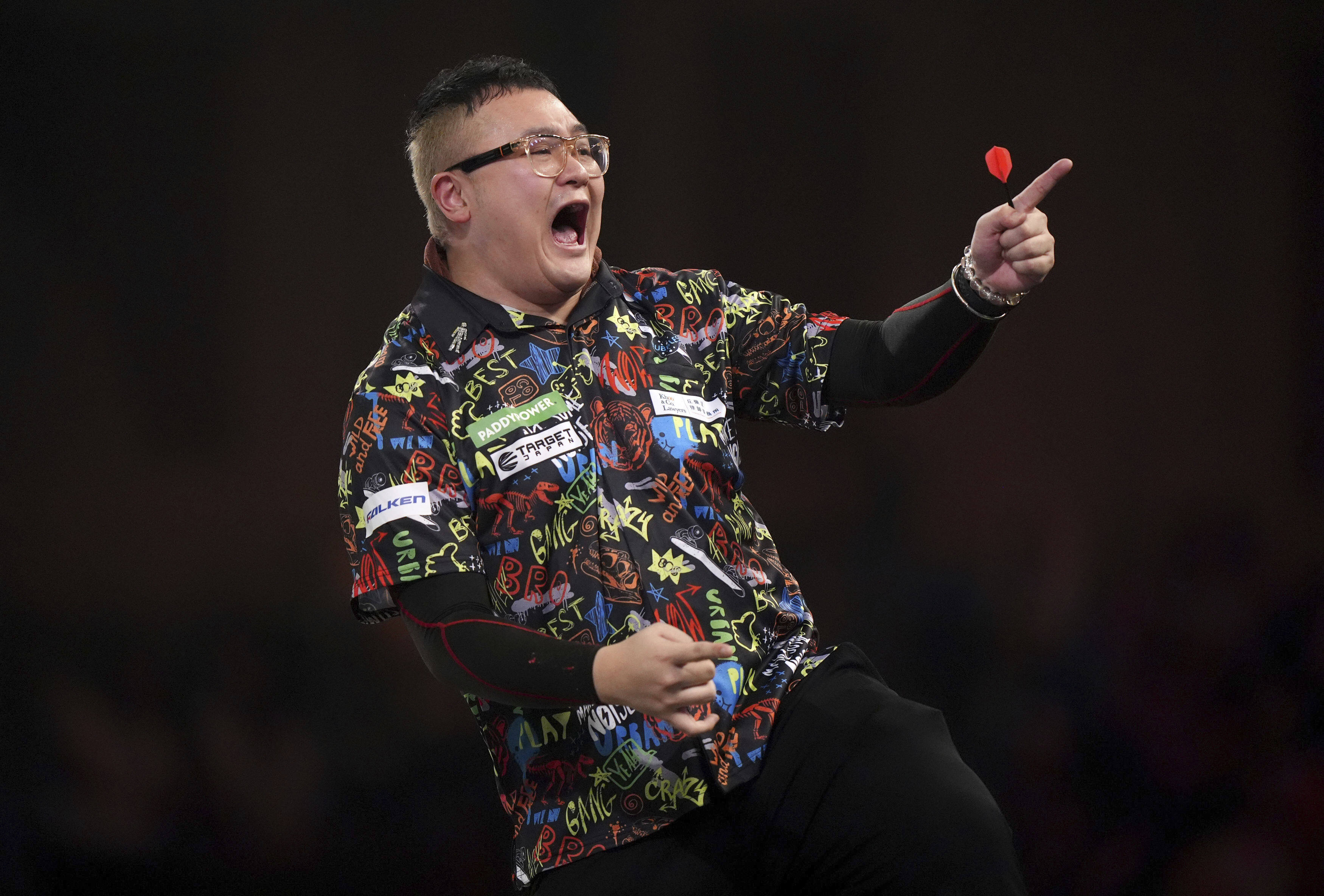 Hong Kong’s Lee Lok-yin celebrates winning his first round match against Chris Landman on day five of the Paddy Power World Darts Championship. Photo: AP