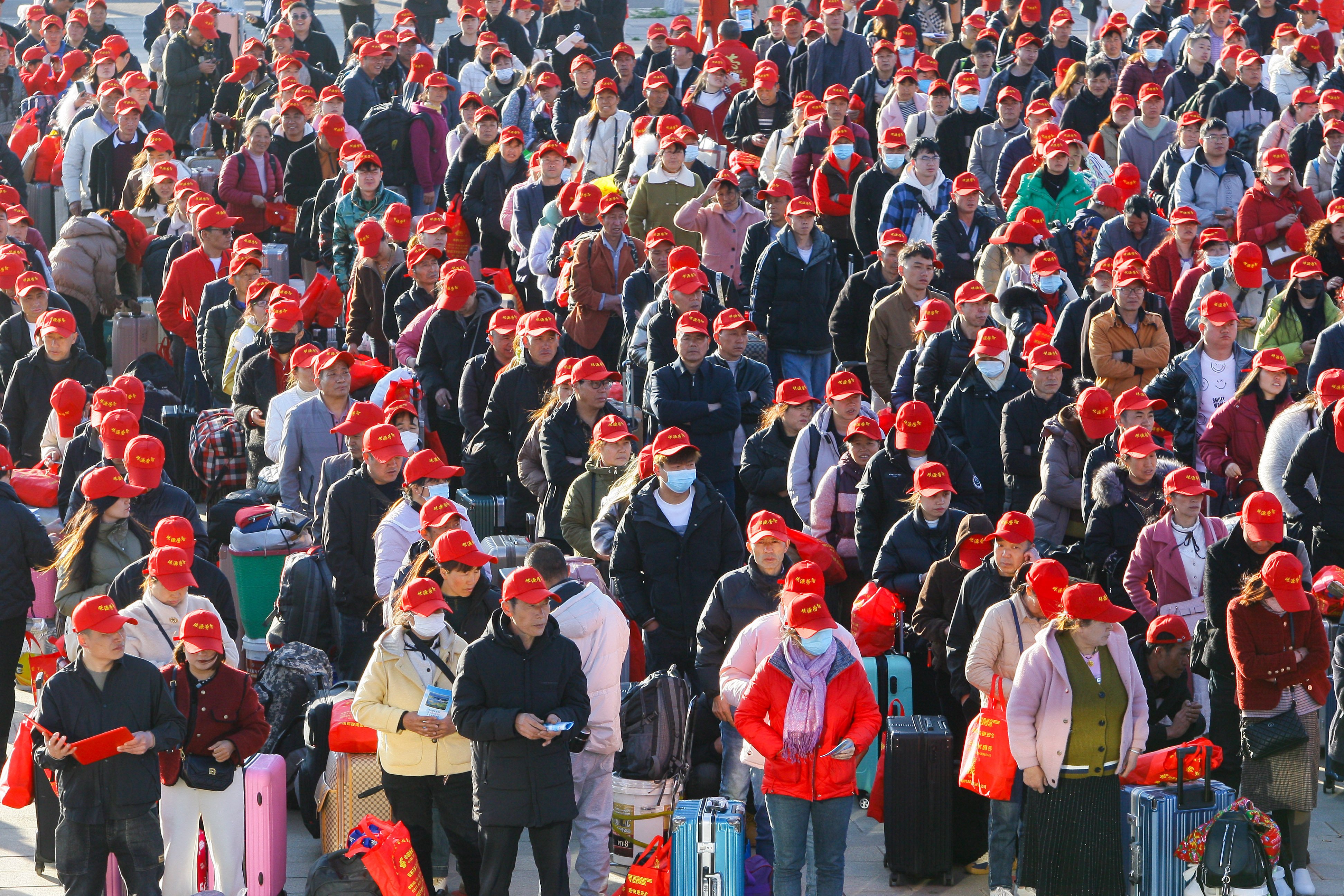 Migrant workers attend a farewell ceremony at Qujing North Railway Station in Yunnan province in February. Photo: VCG via Getty Images