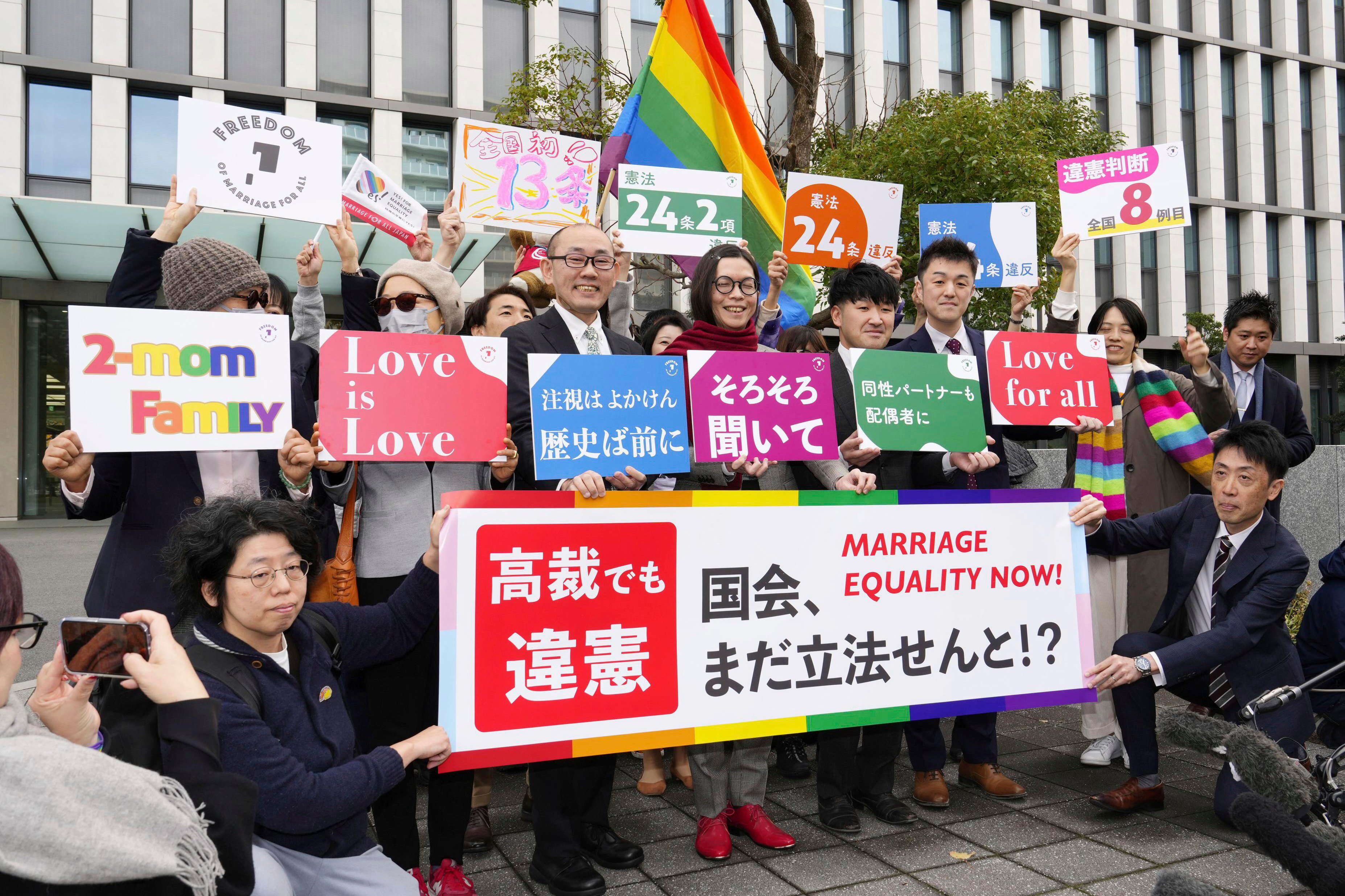 Plaintiffs and their supporters celebrate after a Japanese high court ruled that the country’s refusal to recognise same-sex marriage is unconstitutional, outside the Fukuoka High Court in southern Japan, on December 13. Photo: AP